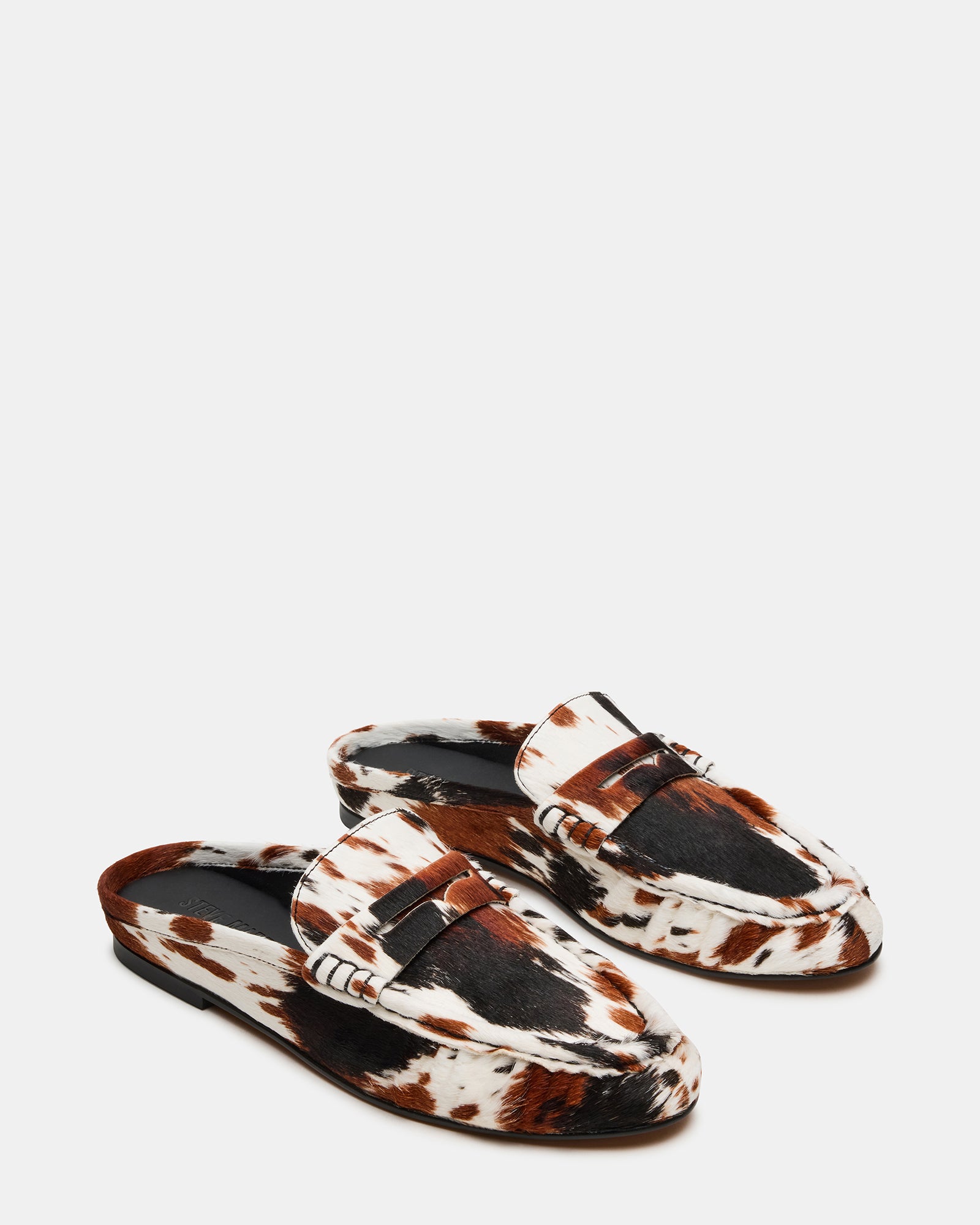 Close-up of cow print leather detailing on slip-on shoes
