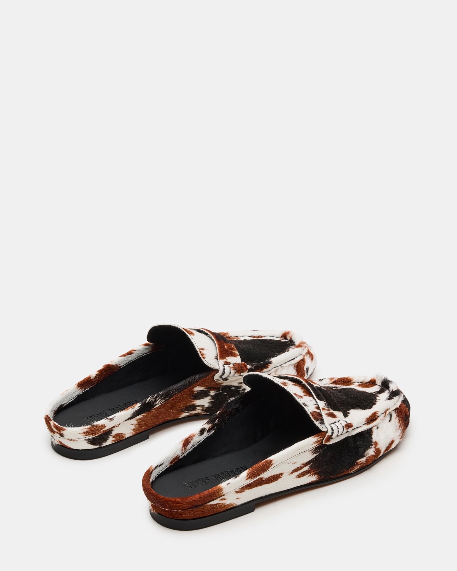 Close-up of cow print leather detailing on slip-on shoes