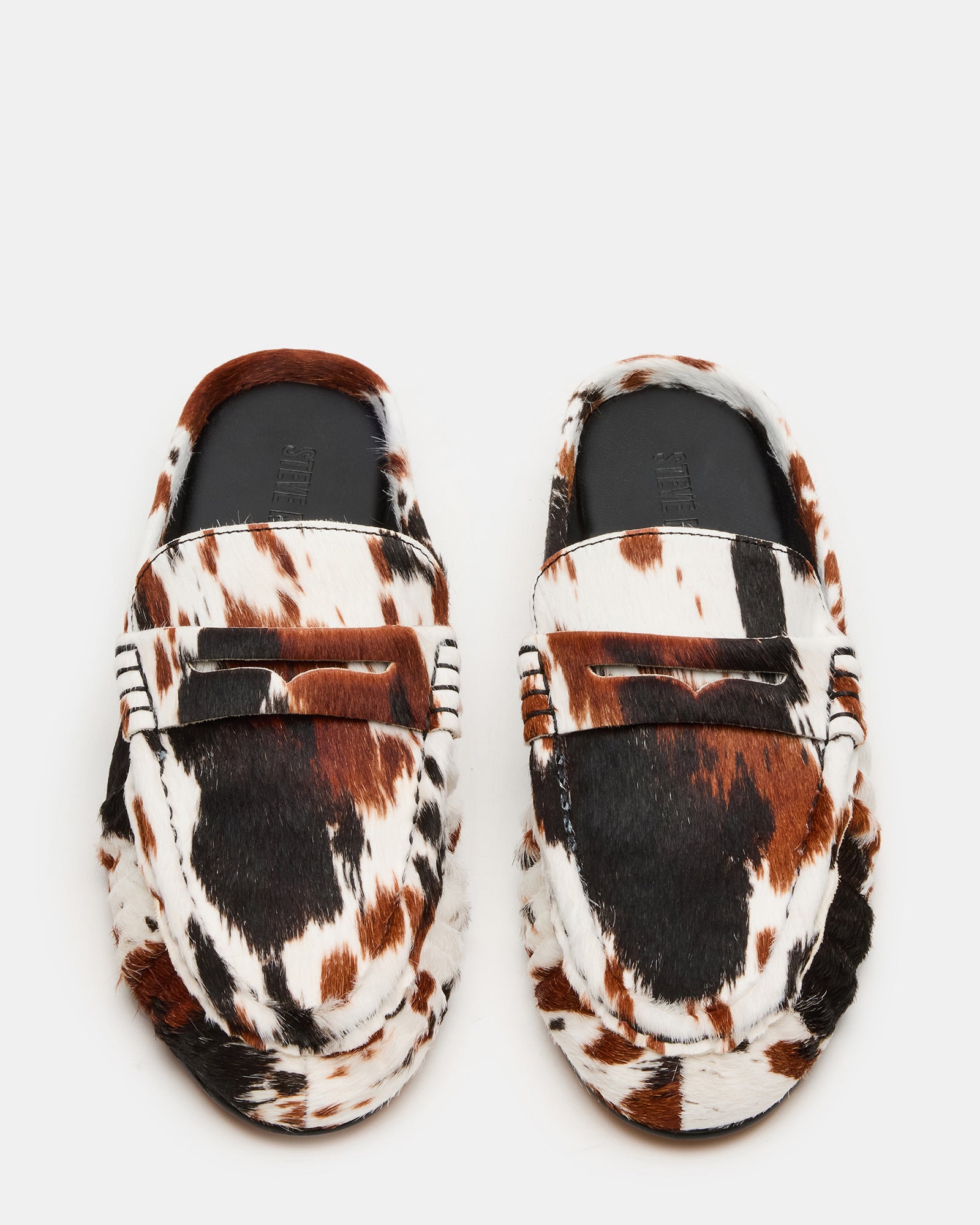 RAFE mens leather slip-on shoes in brown cow print, side view on urban sidewalk
