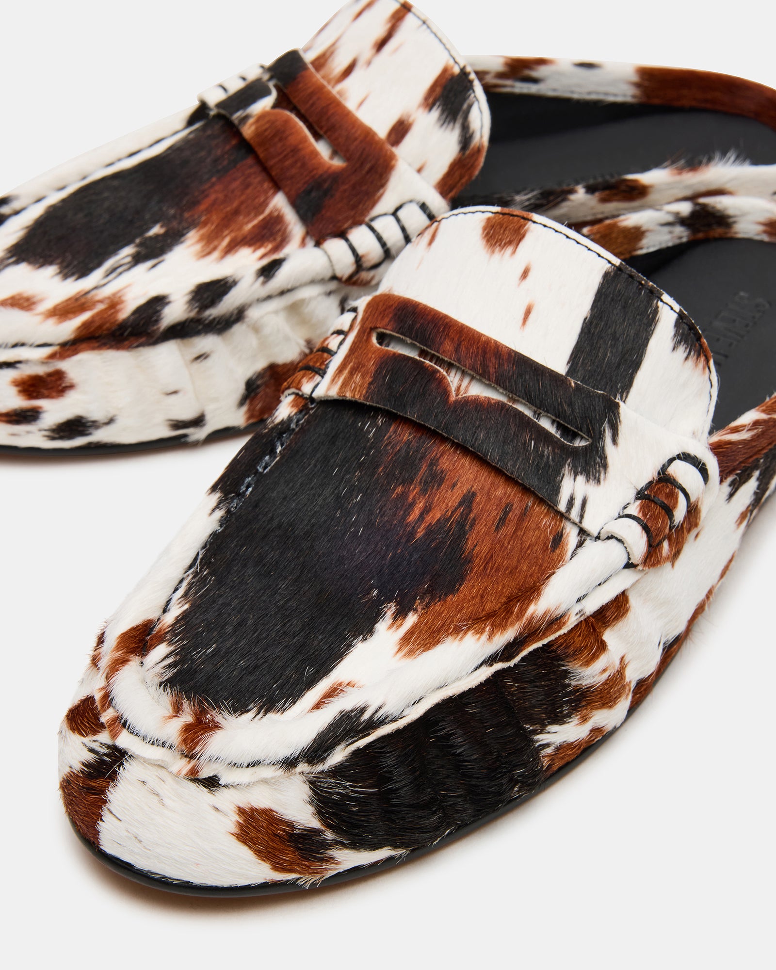 Stylish mens leather slip on shoes paired with dark denim jeans