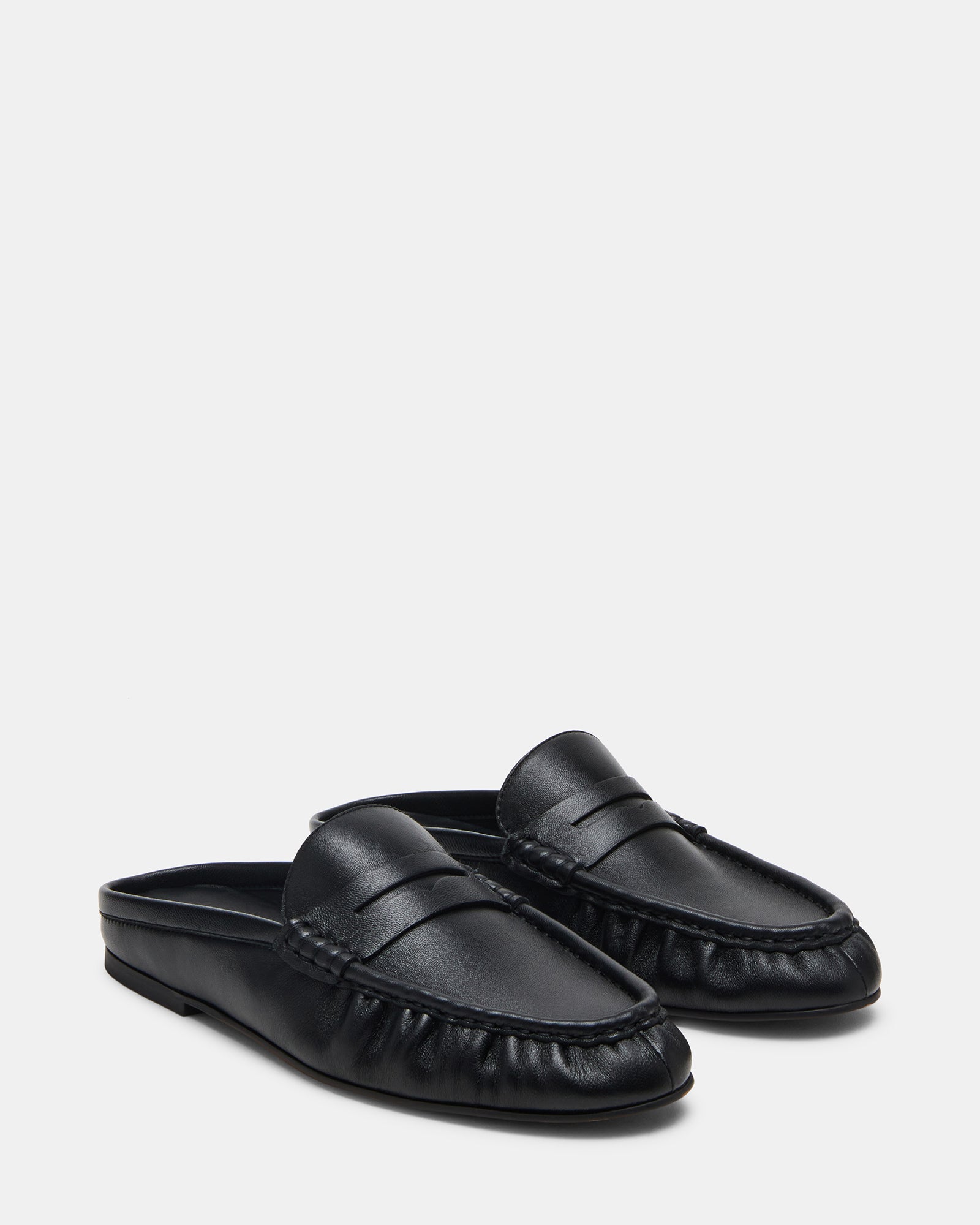 Side angle of slip-on black leather flats showing comfort features