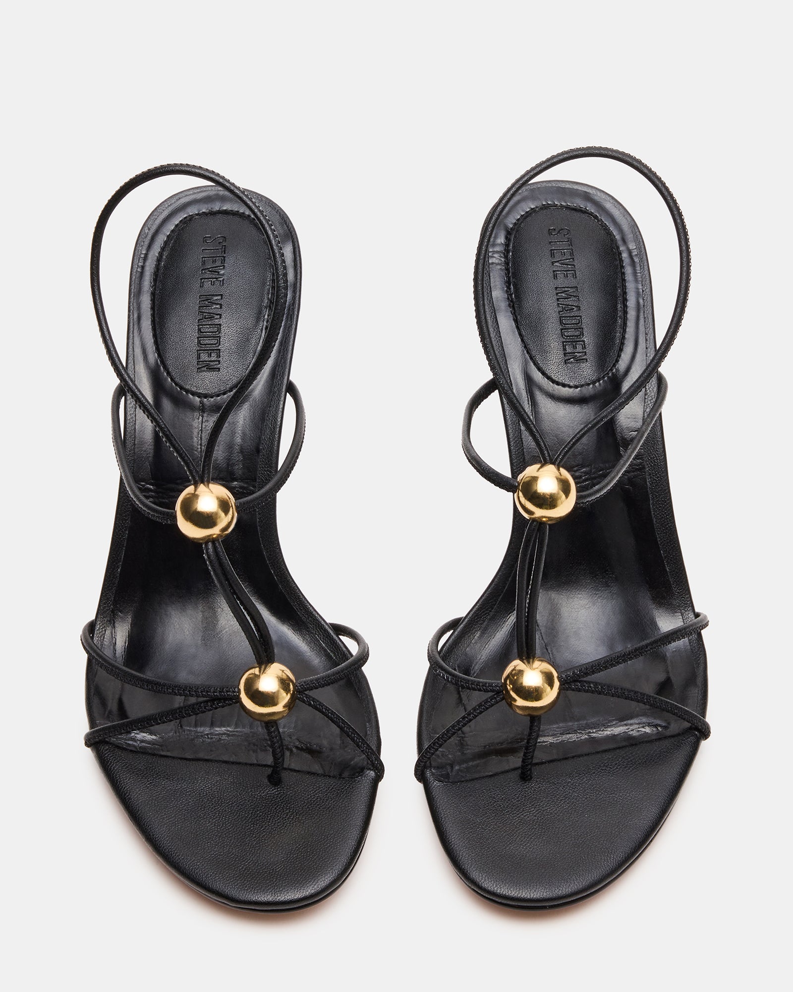 Close-up of the nude strappy heels featuring a stylish stiletto design.