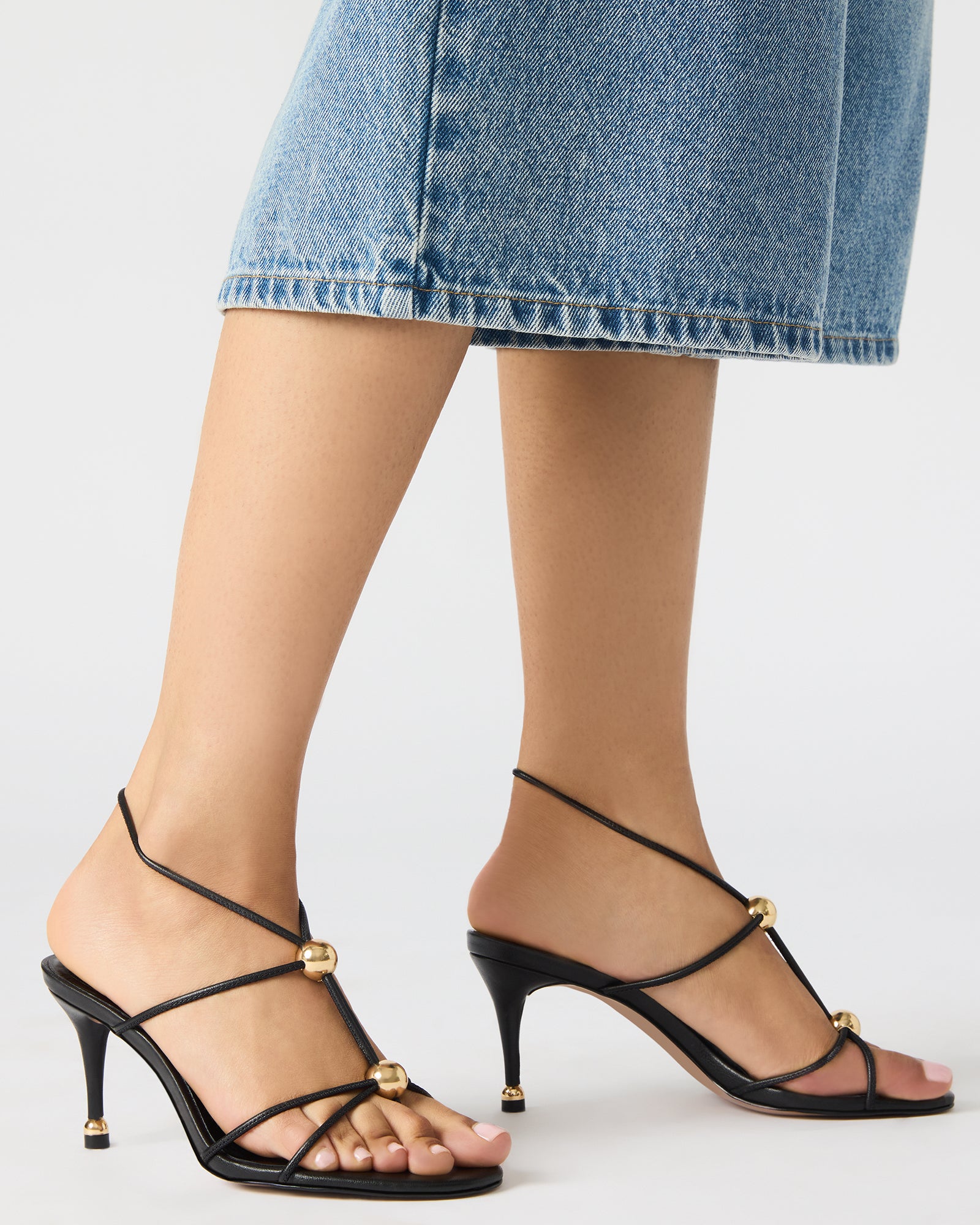Close-up of the nude strappy heels featuring a stylish stiletto design.