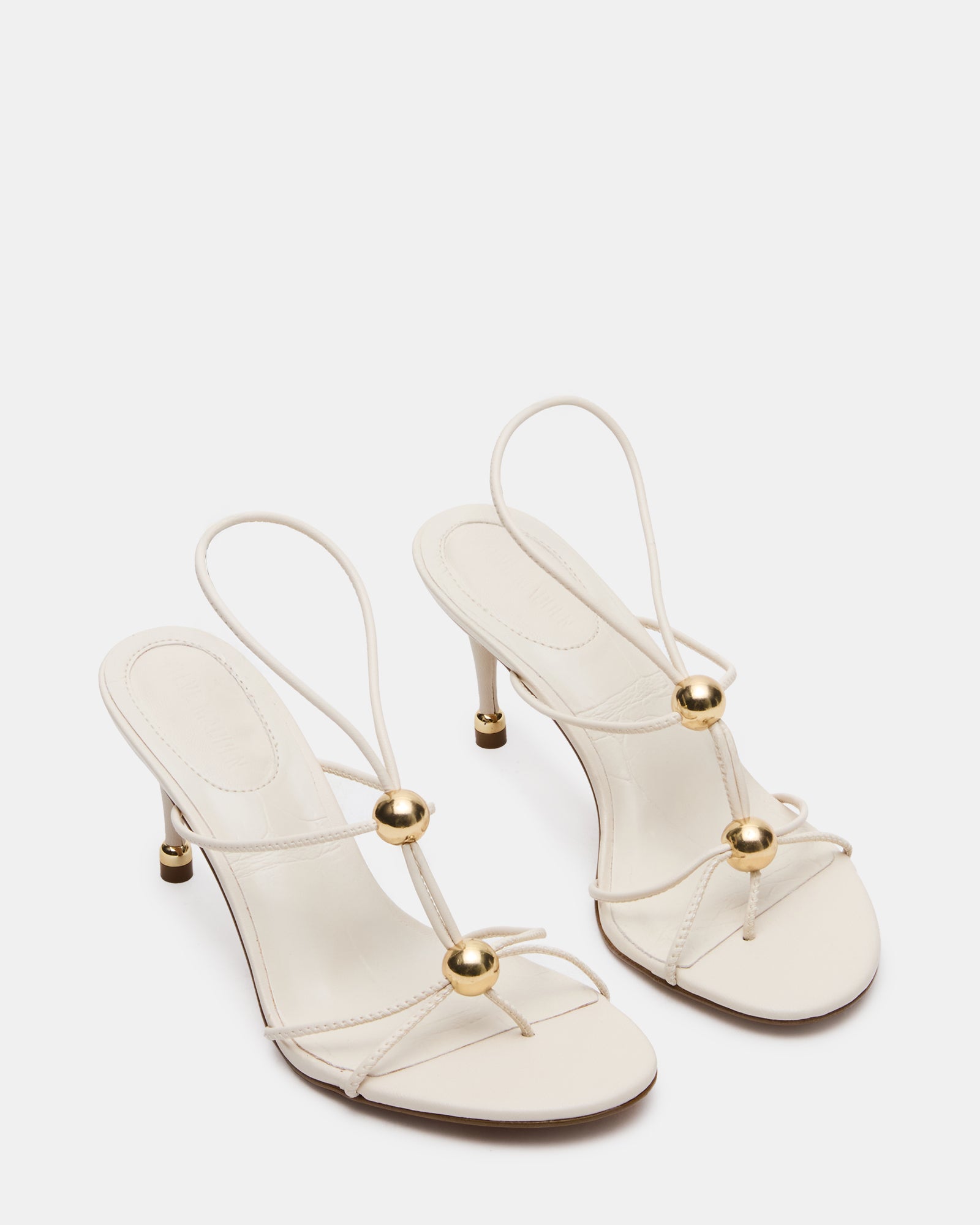 Elegant black heels with gold accents, styled for a night out.