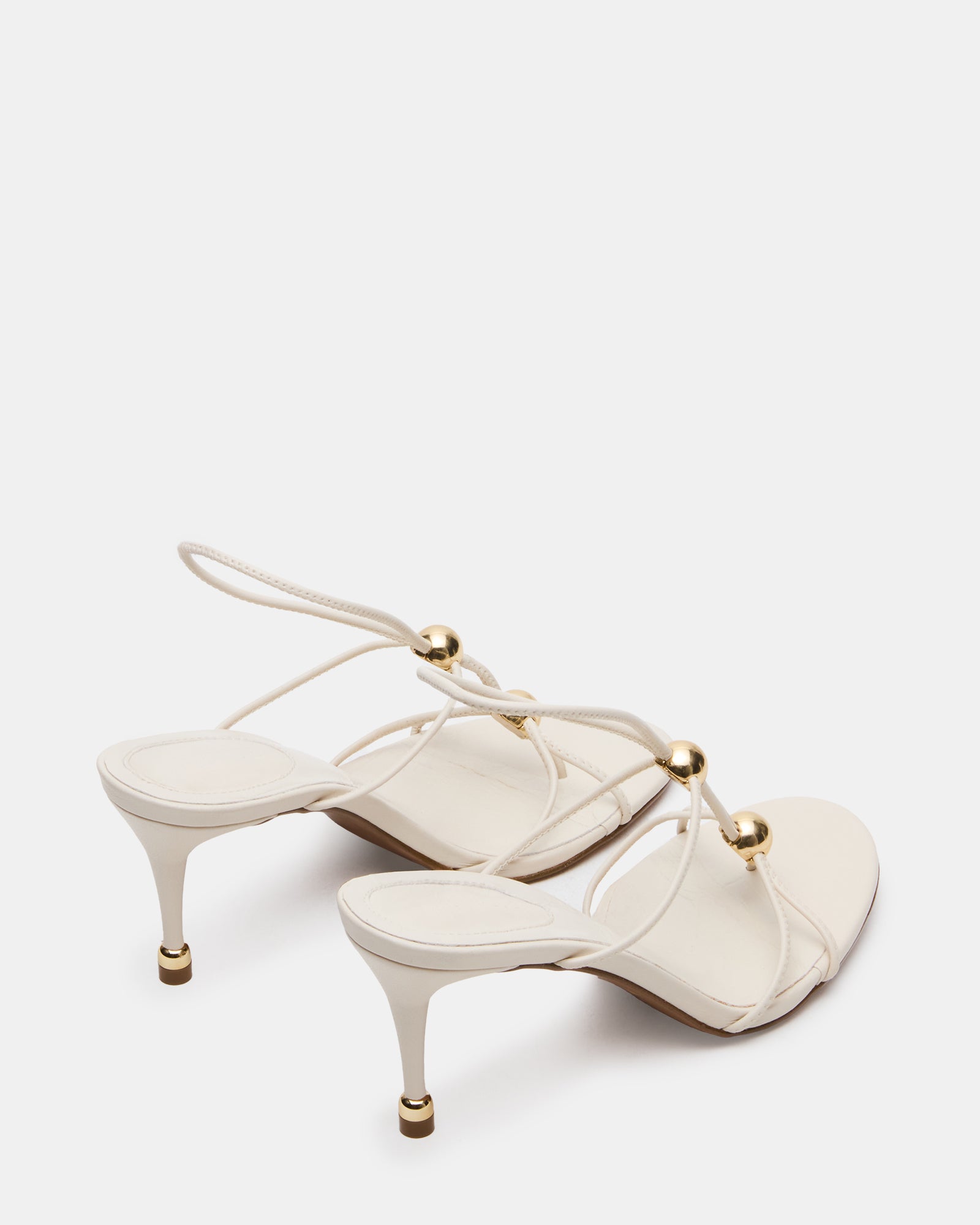 Elegant black heels with gold accents, styled for a night out.
