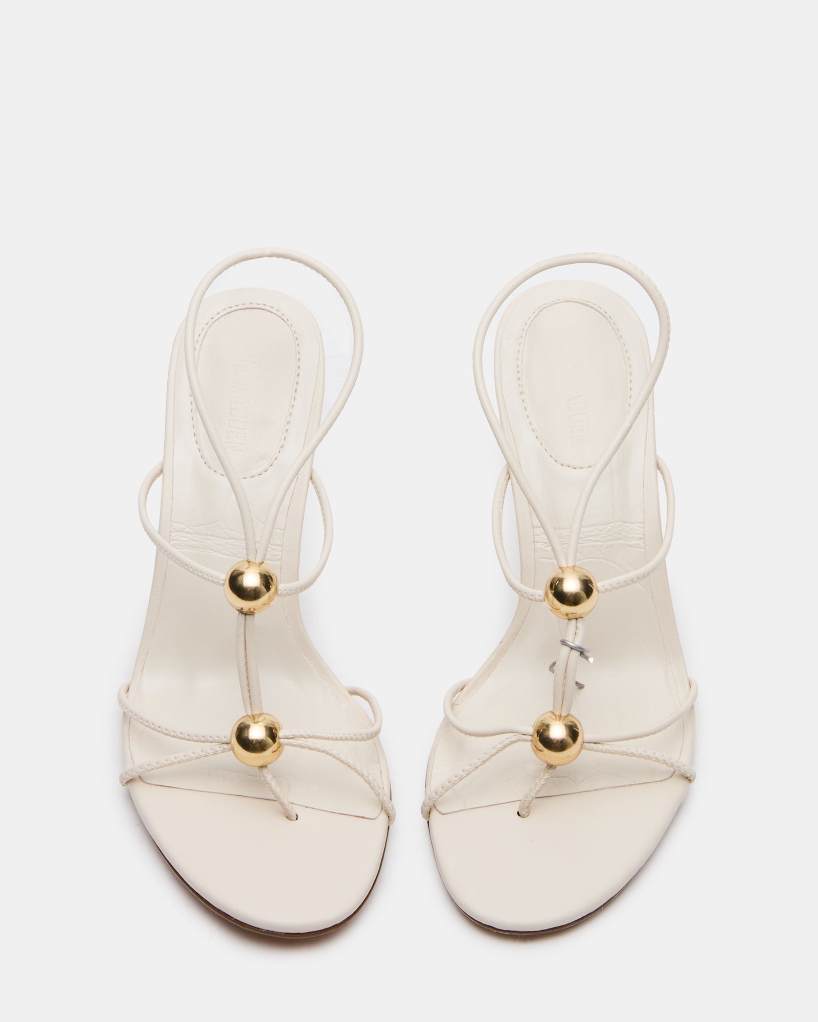 Ramos gold heels showcasing strappy design from the side.