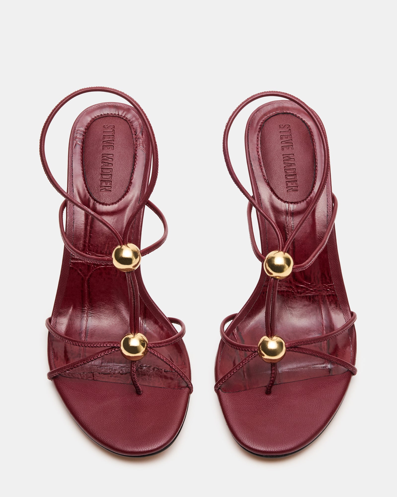 Side view of Ramos Strappy Stiletto Heels with gold accents.