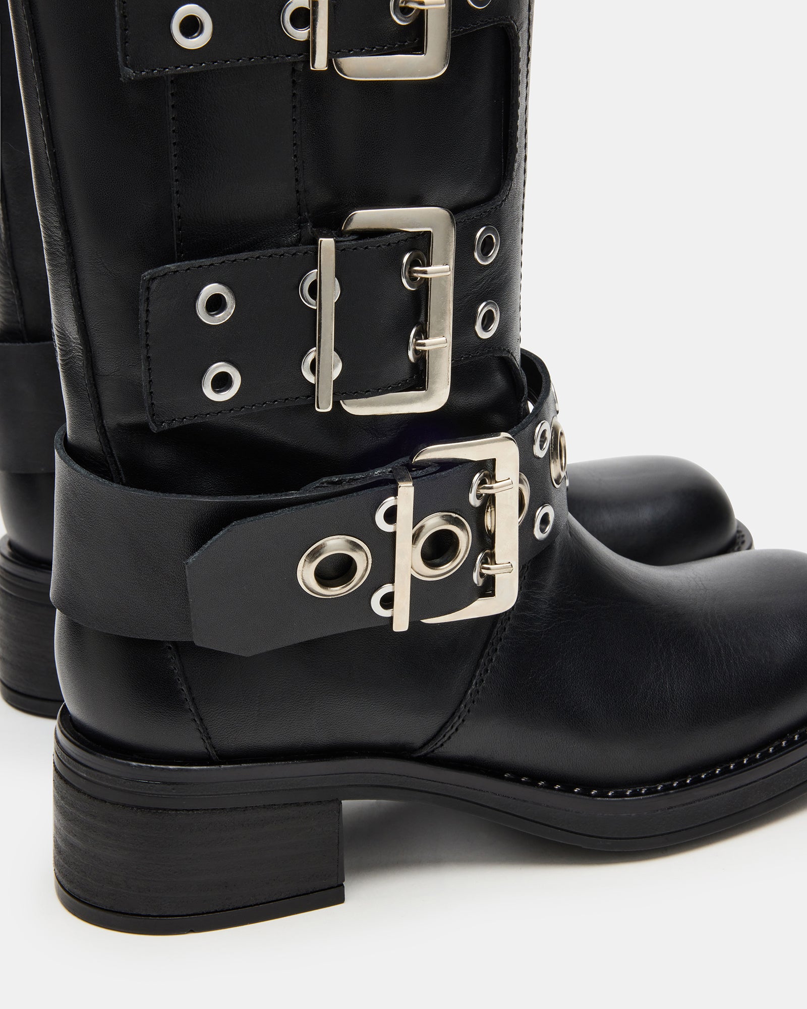 Side view of the square toe cowboy boots, emphasizing the unique design and grommet accents.