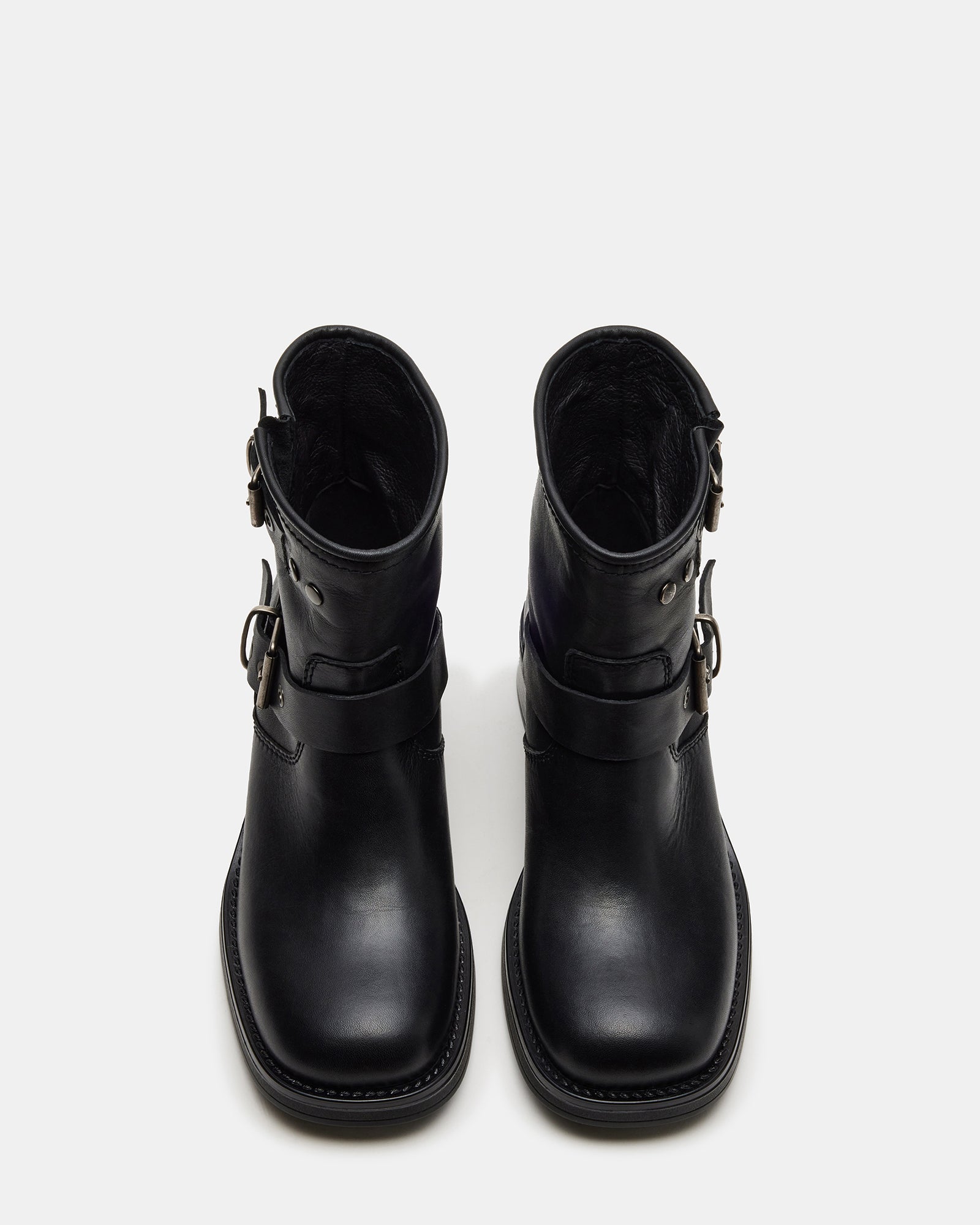 Side view of black ankle boots styled with jeans for daily urban wear