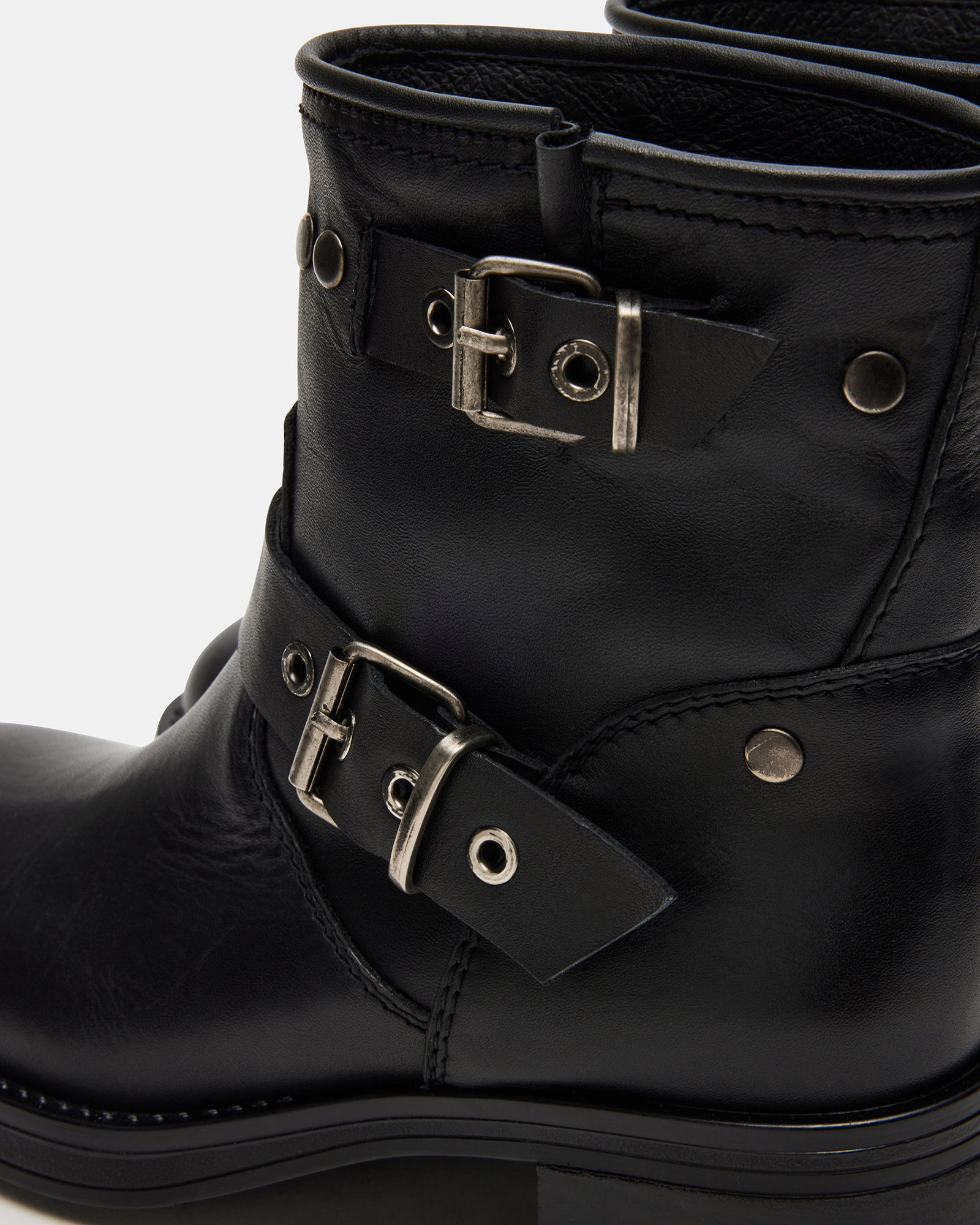 Front angle of moto boots showing 2-inch heel and structured black leather design