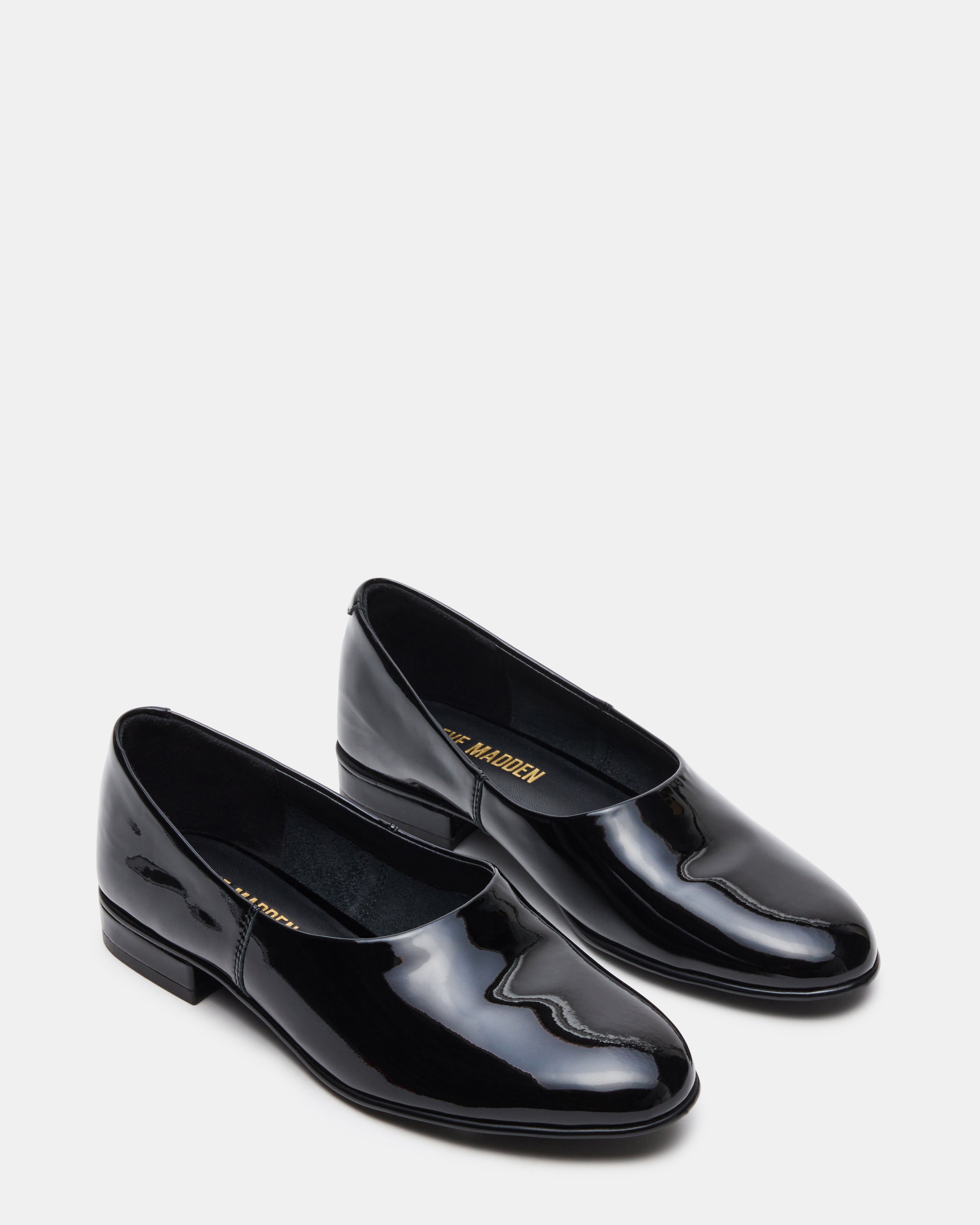 Side view of patent leather flats styled with cropped trousers