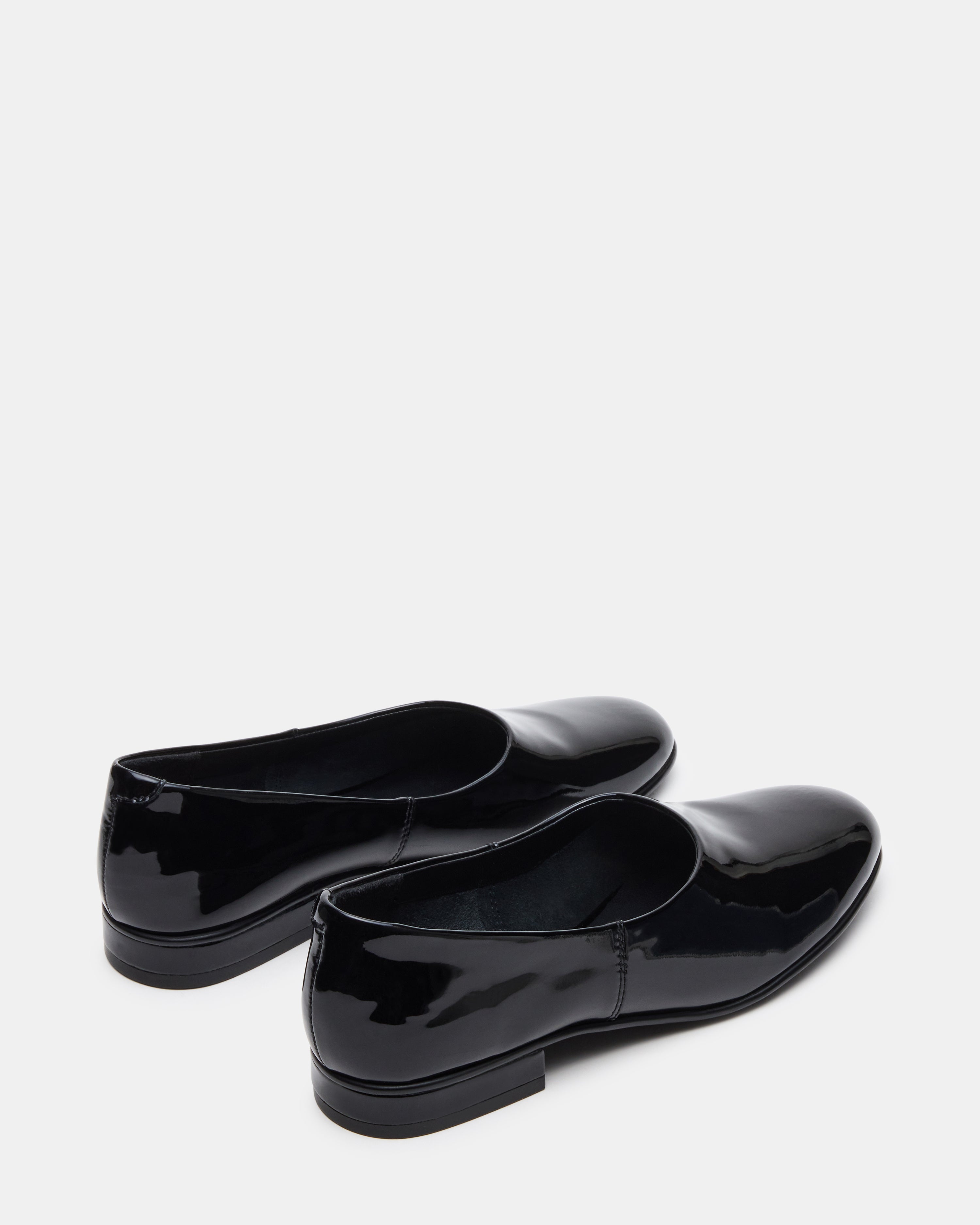 Side view of patent leather flats styled with cropped trousers