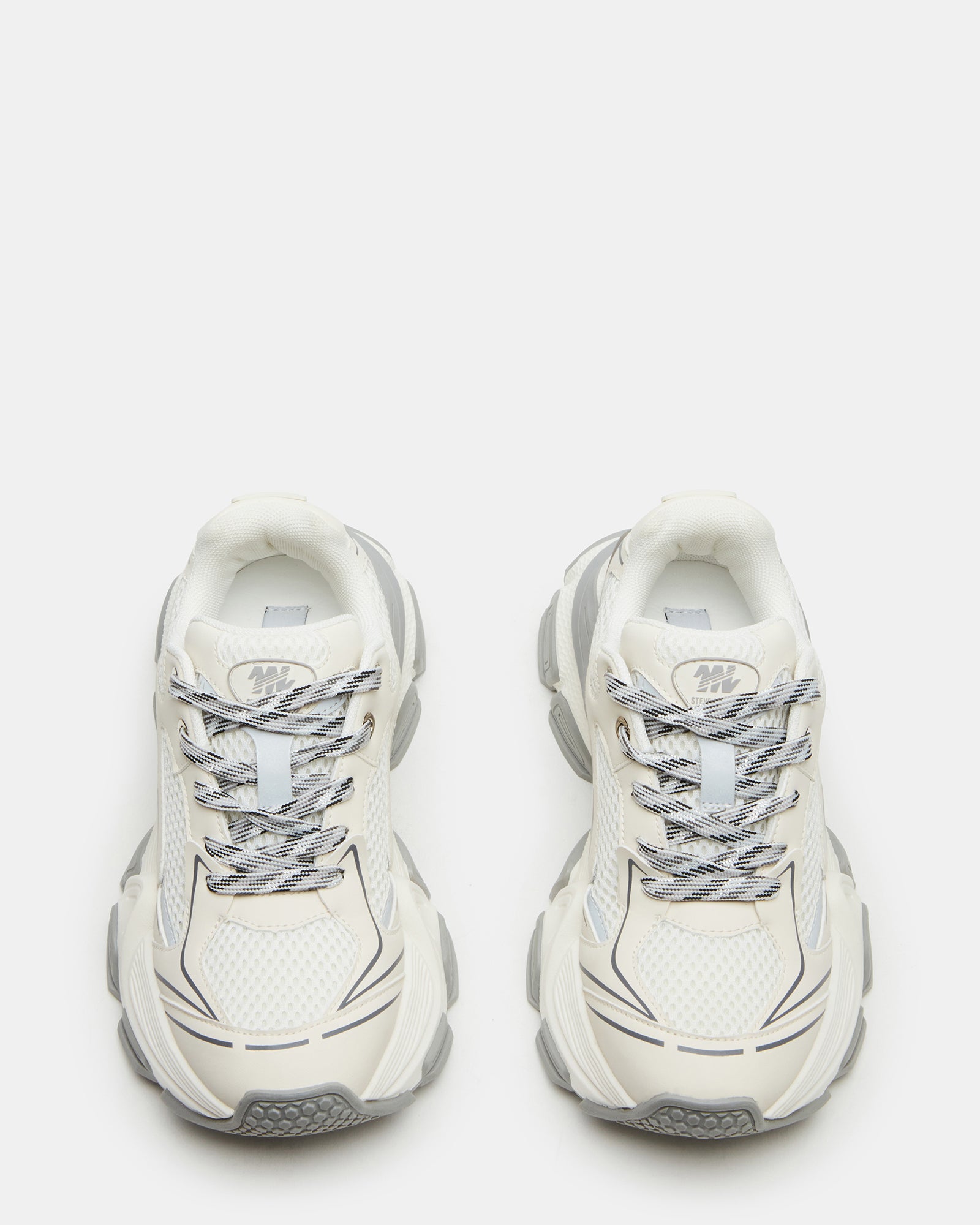 Side view of white platform sneakers showcasing chunky sole design