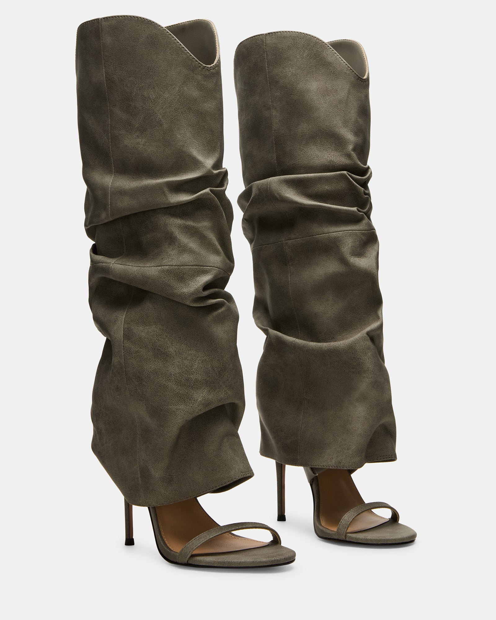 Side view of the grey knee-high boots highlighting the distressed finish and sleek design