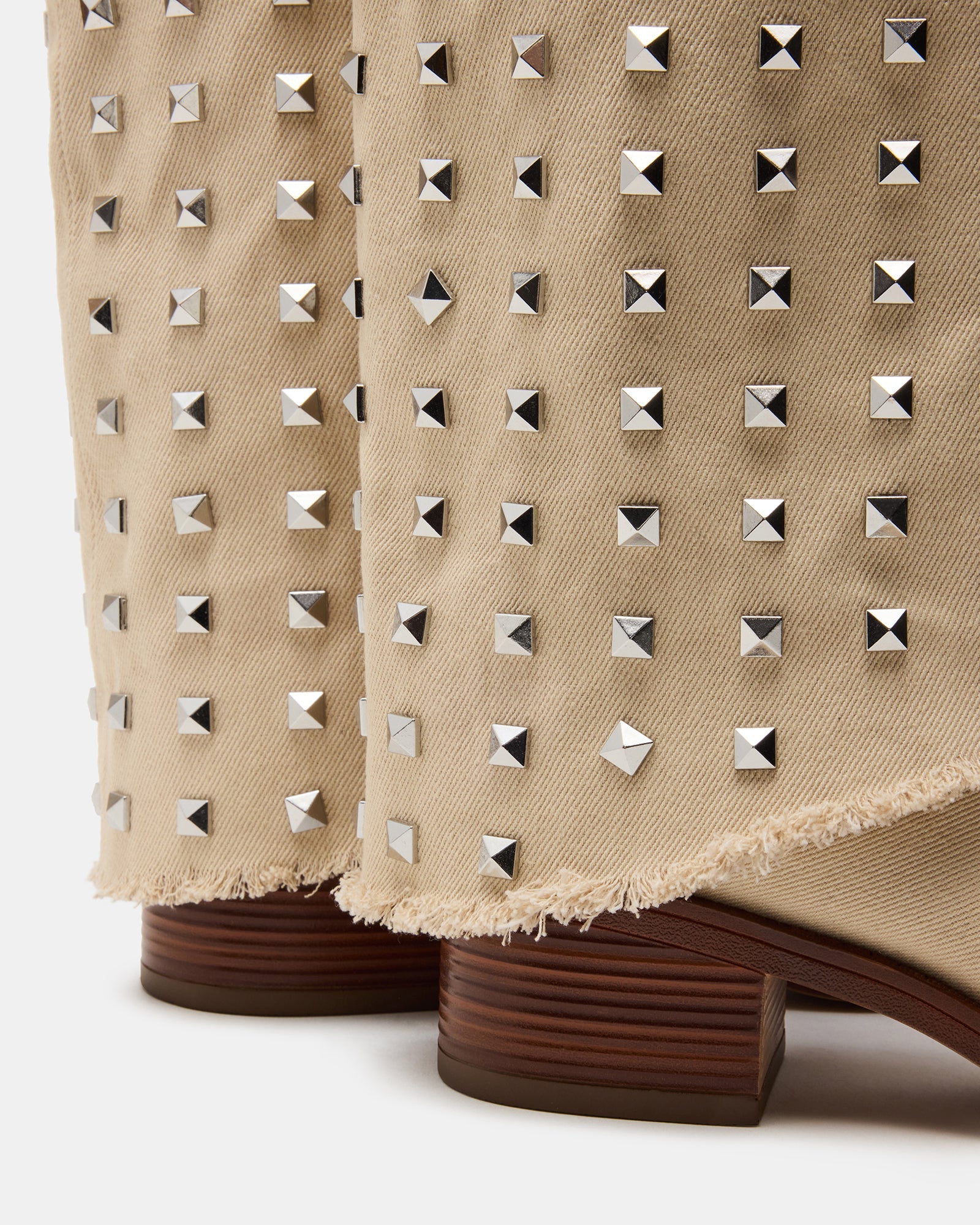 Close-up of fold-over design on beige square toe cowboy boots.