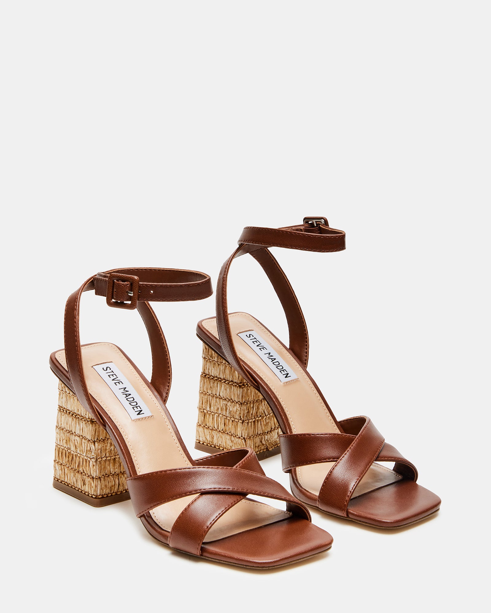 Model wearing Renley brown leather block heel sandals in a summer outfit.
