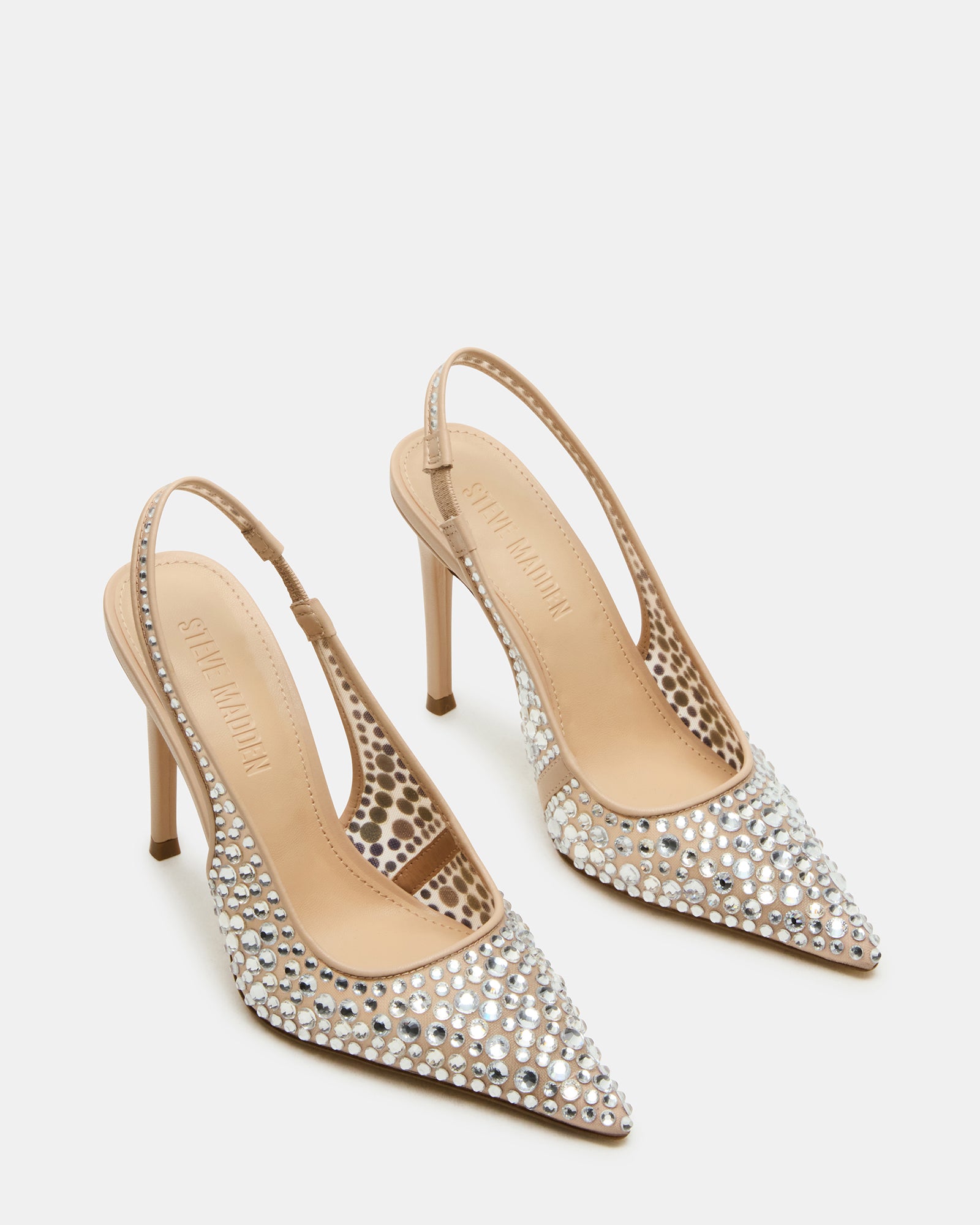 Full view of black pumps with rhinestones styled with a dress