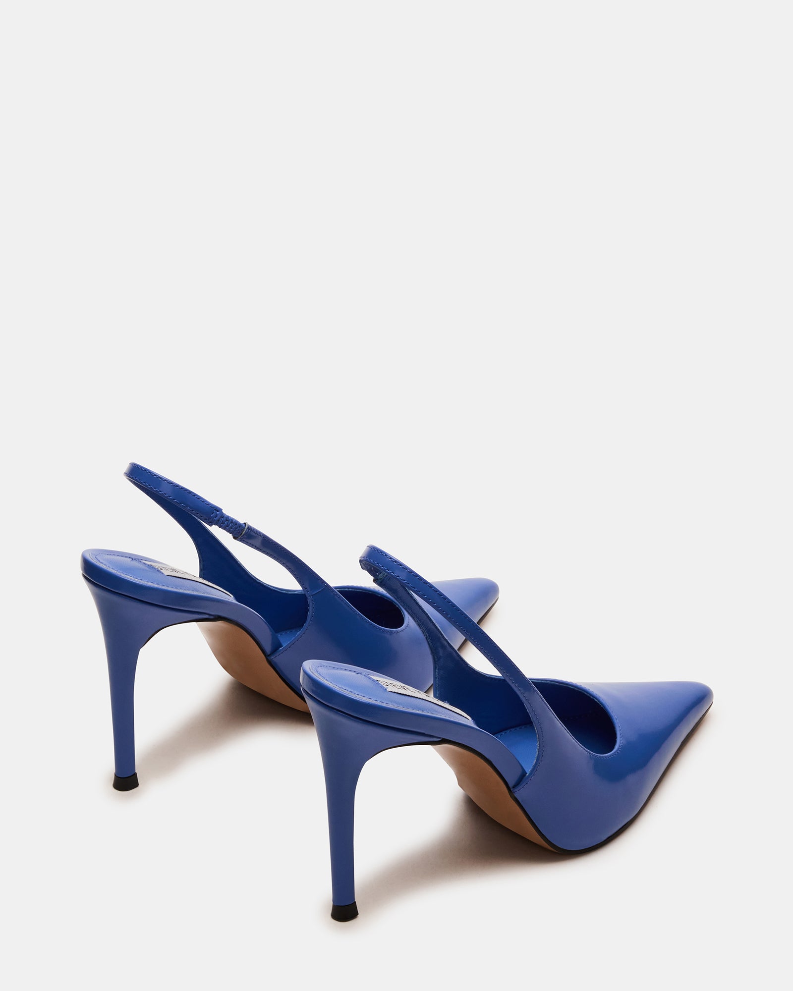 Side view of navy blue leather pumps on a model, styled with an evening dress