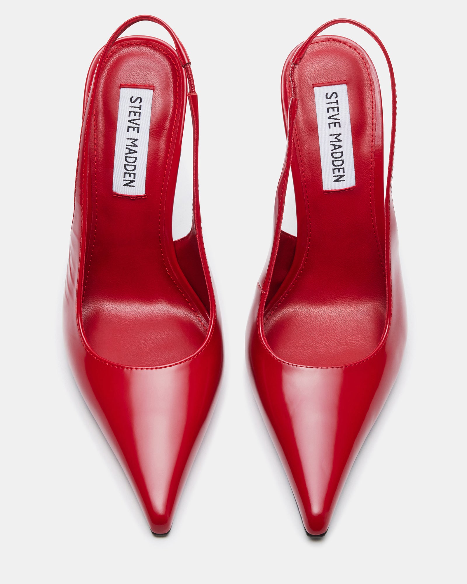 Elegant white pointed toe pumps for women on a city street