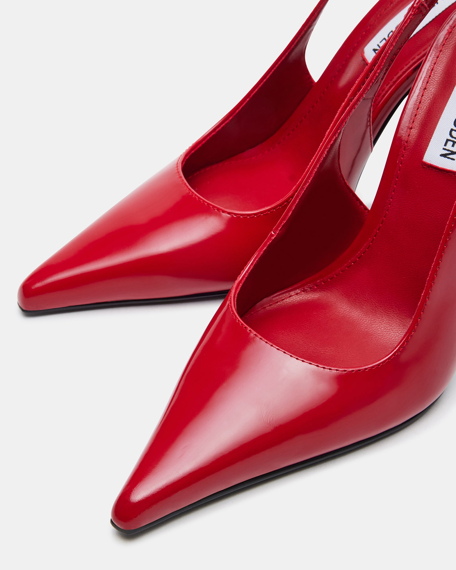 Side view of Reyes Red pointed-toe slingback pumps with stiletto heels