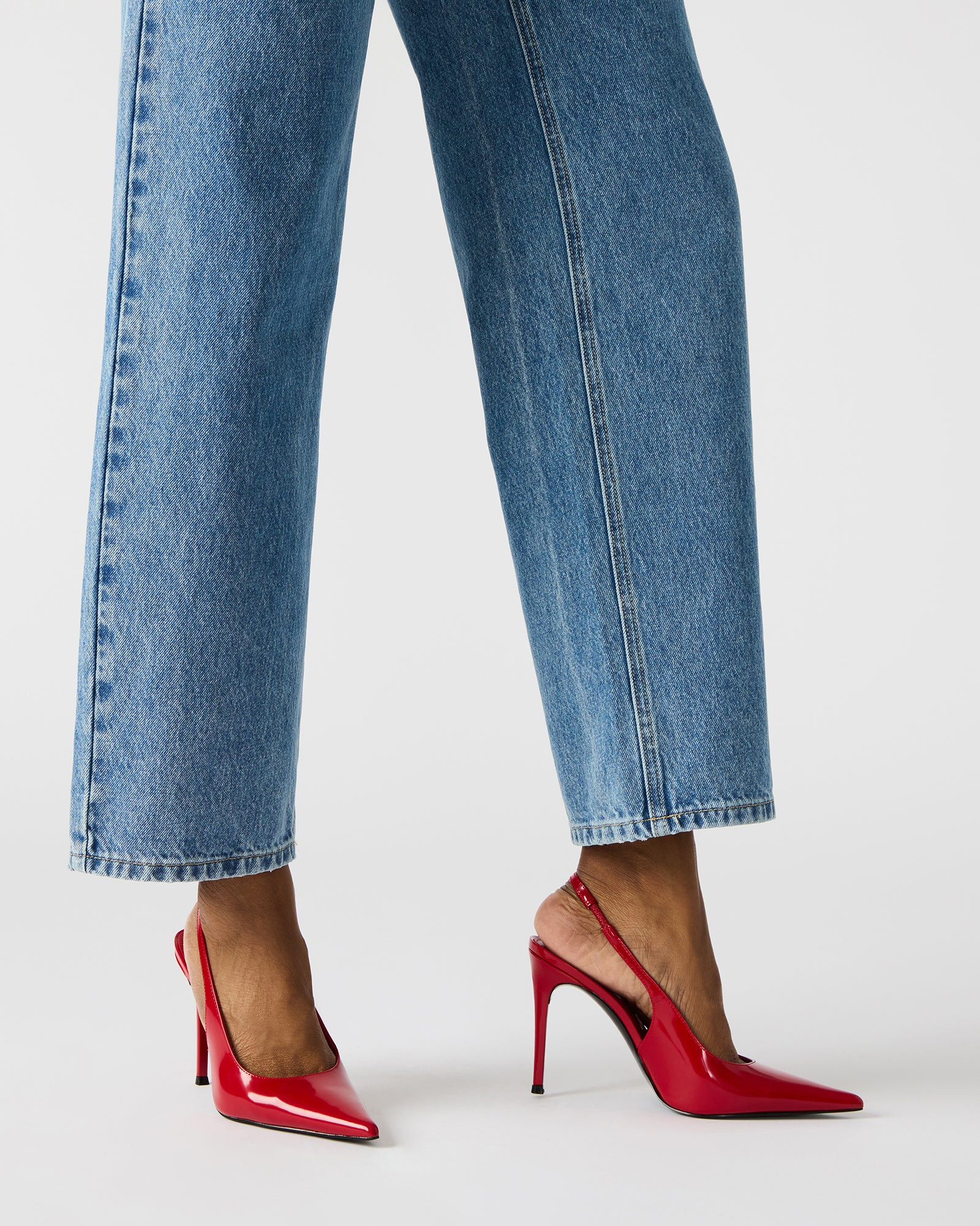 Elegant white pointed toe pumps for women on a city street