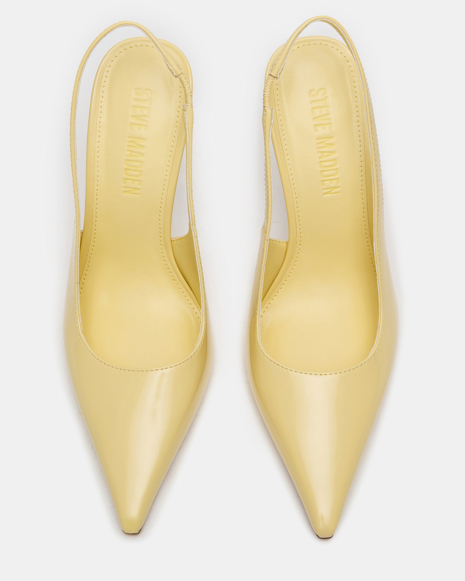 REYES white slingback heels styled with a black cocktail dress