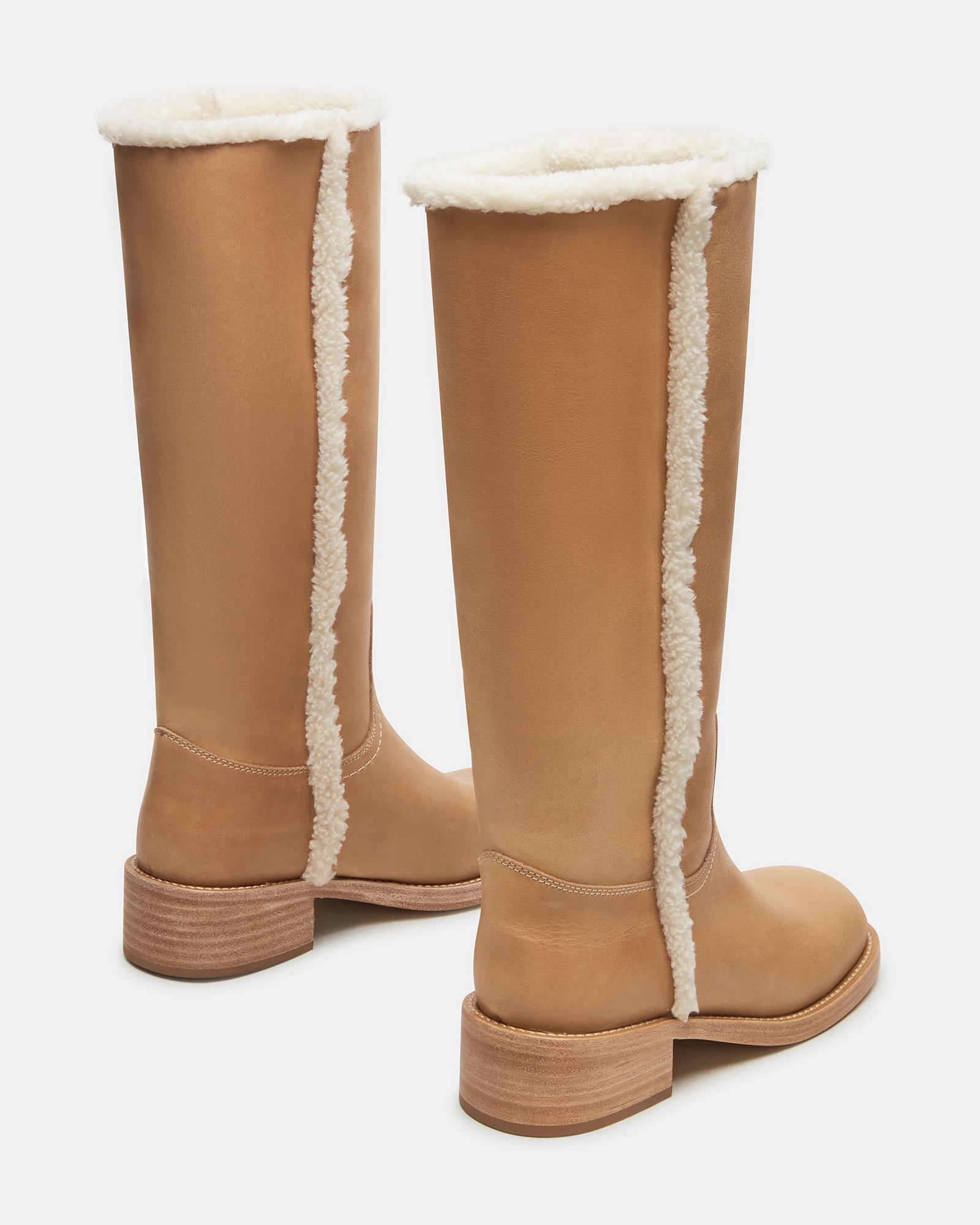 Side profile of black leather boots with square toe design