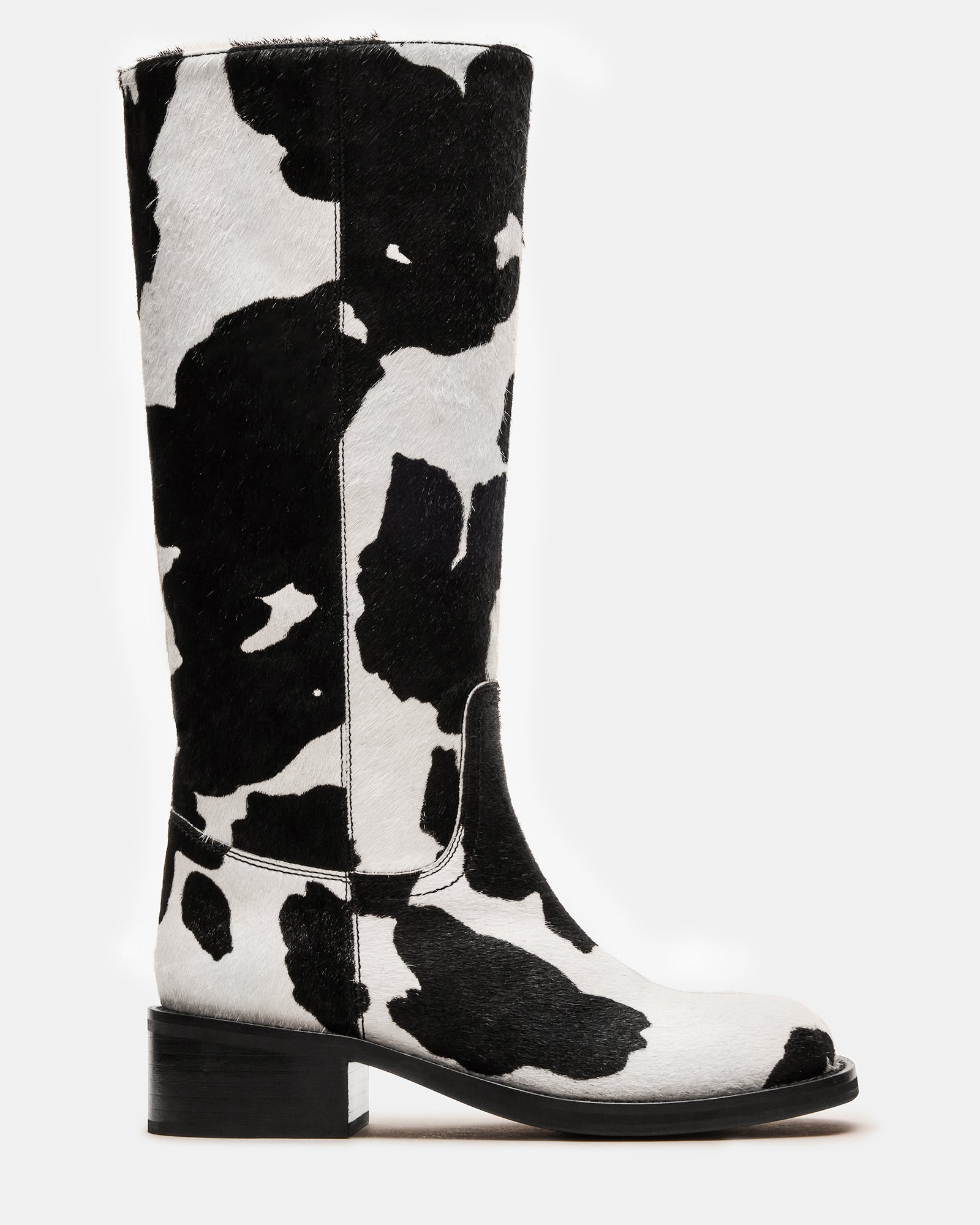 Close-up of the black cow print knee-high boots featuring a square toe.