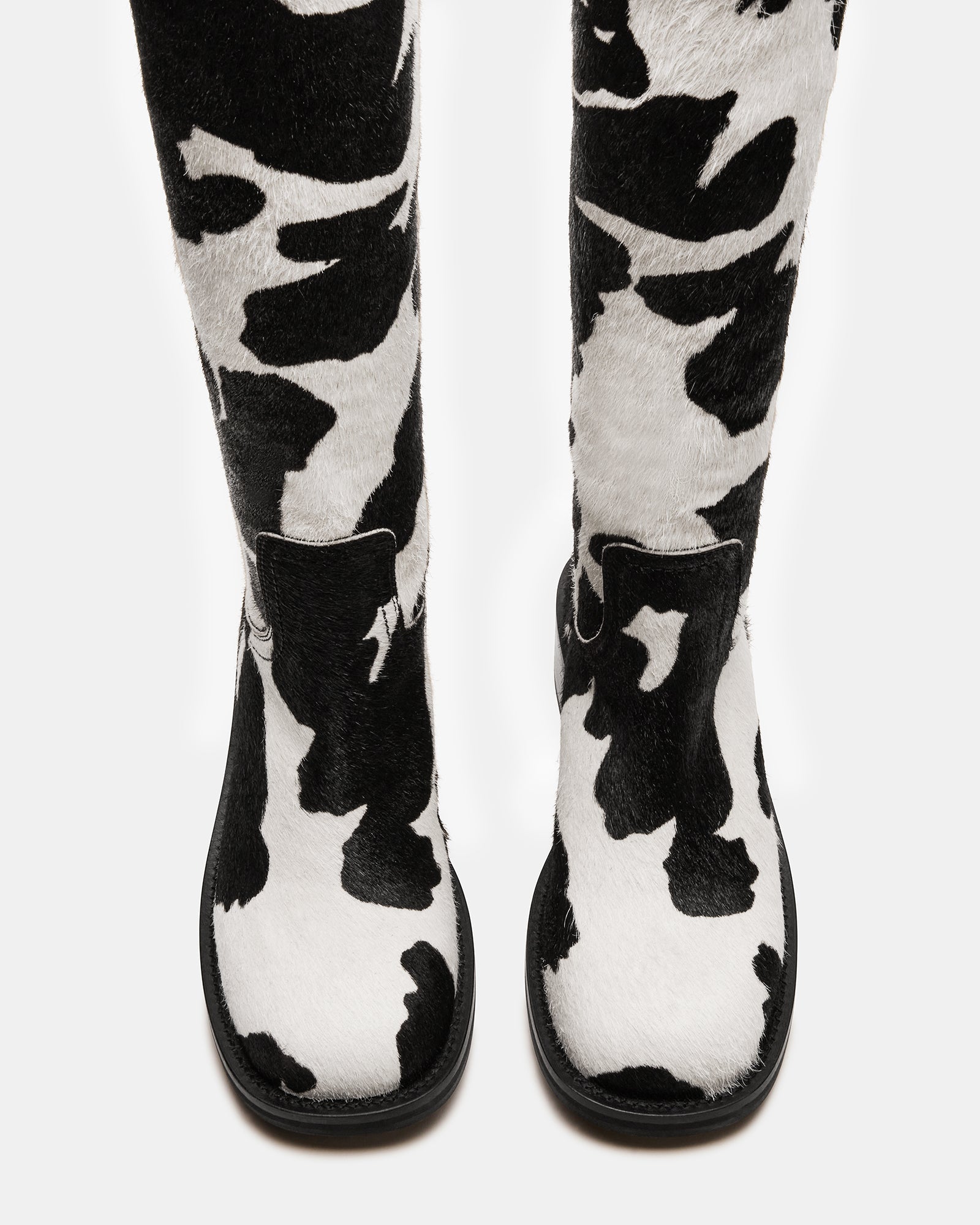 Side view of the black leather boots showcasing their elegant design.