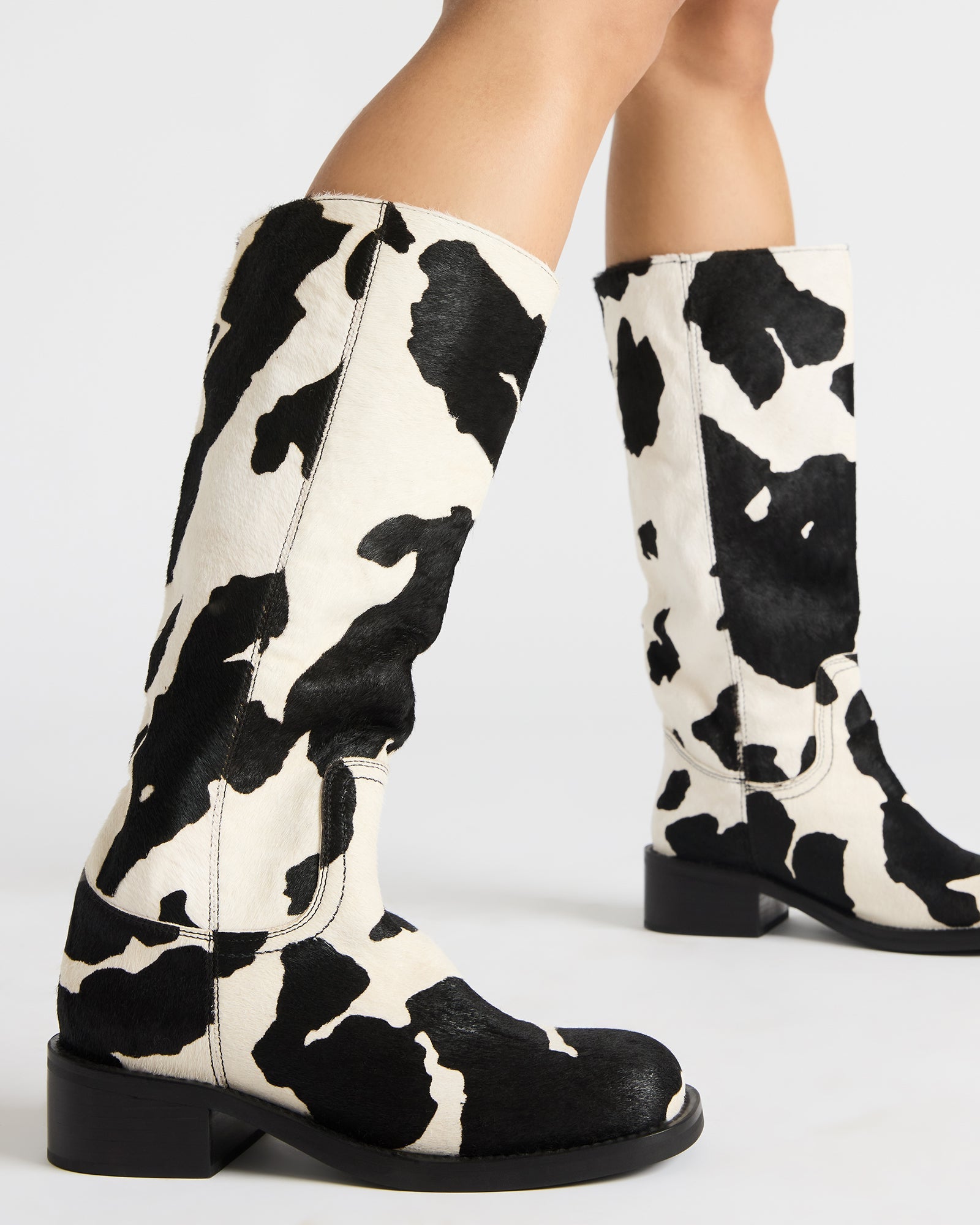 Side view of the black leather boots showcasing their elegant design.