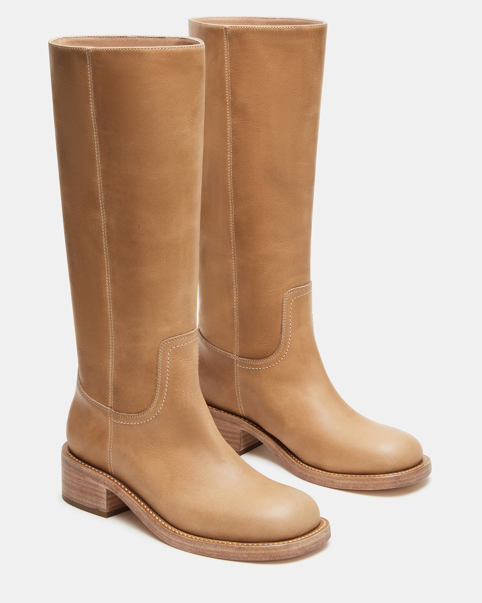 Square toe boots displayed with fall wardrobe on wooden bench