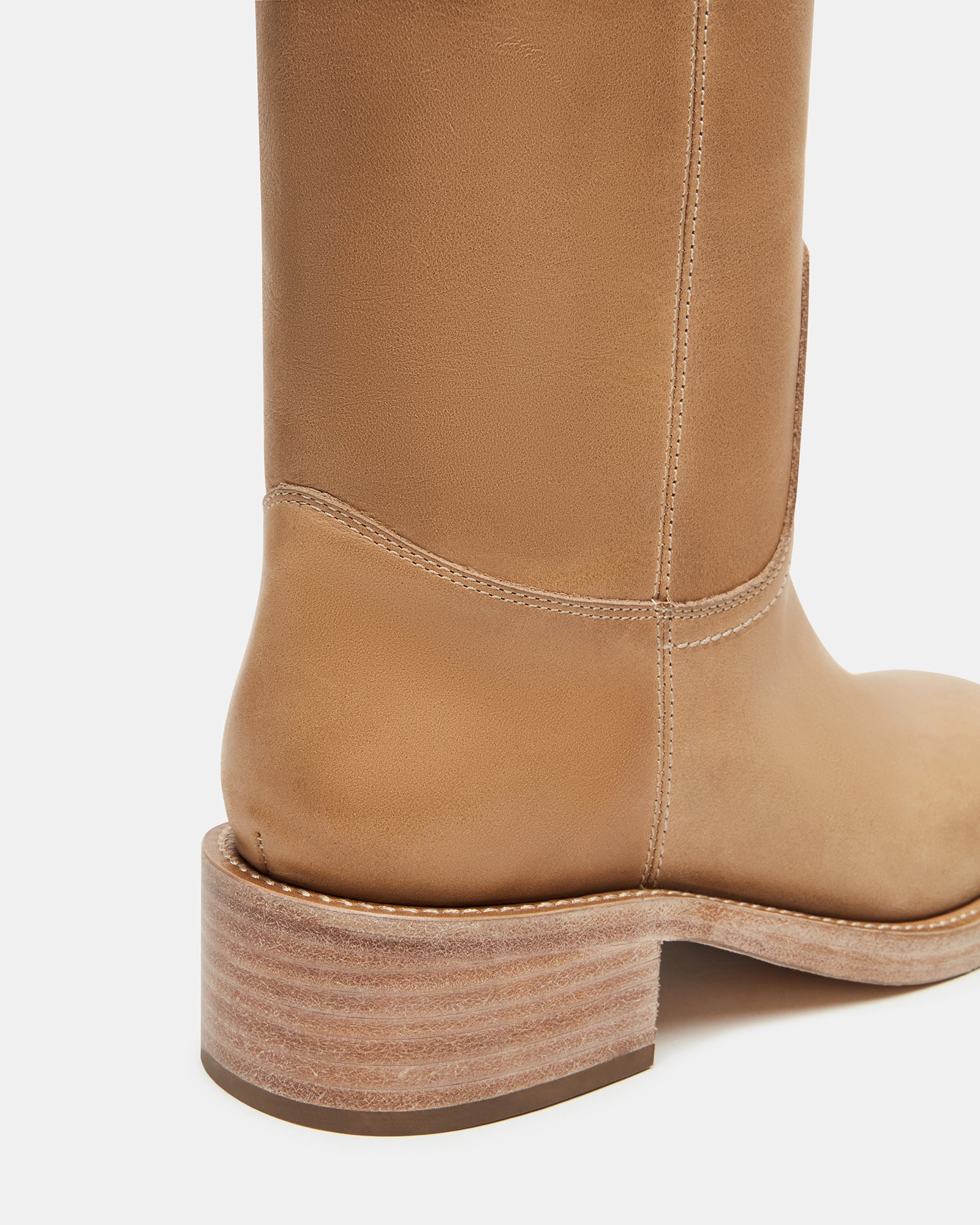Side profile of leather boots worn in downtown setting