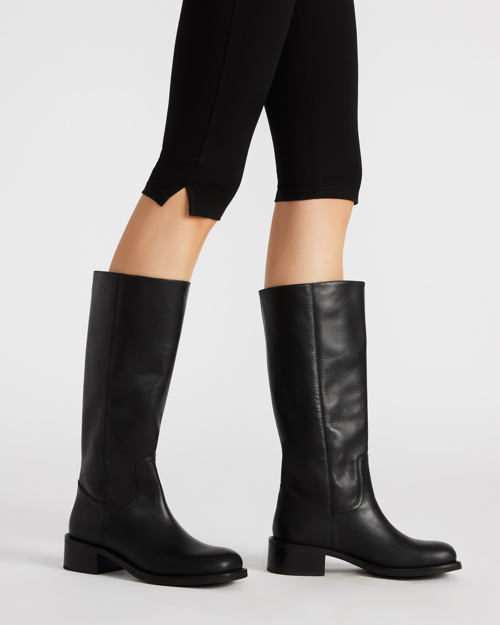 Full view of the silver leather cowboy boots worn with casual jeans for a modern Western look