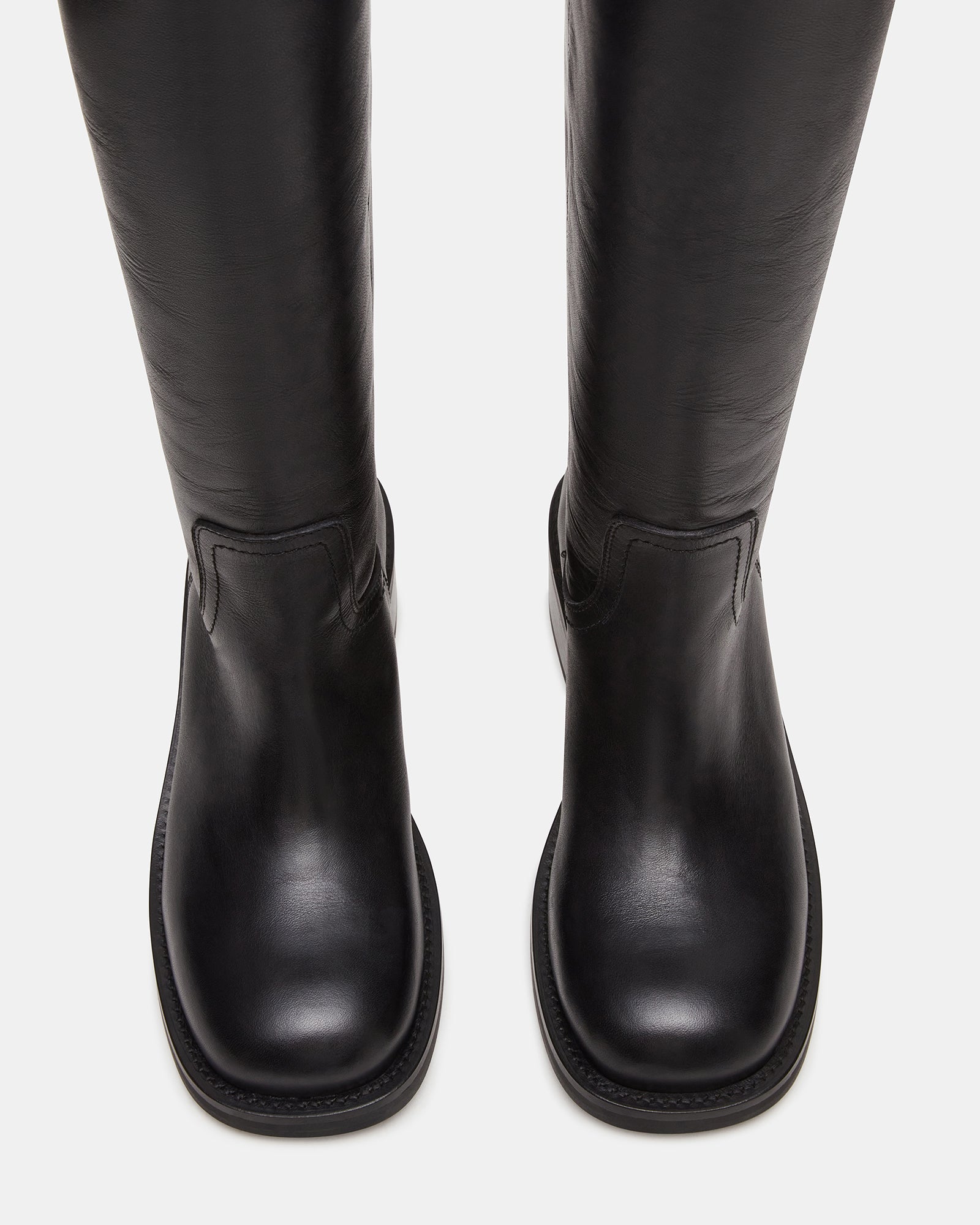 Front view of RIGGS black leather boots with square-toe detail, ideal for fashion-conscious women