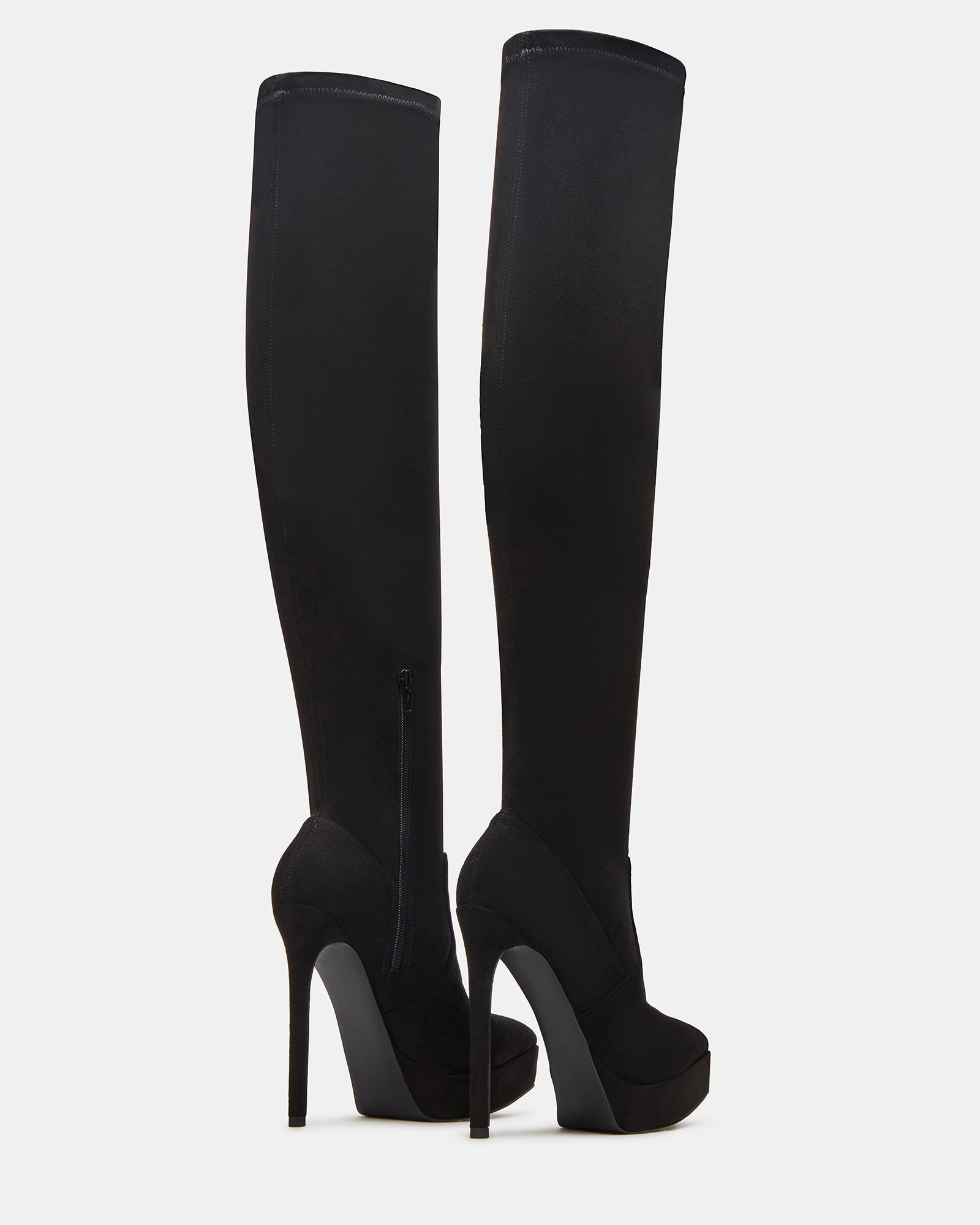 Close-up view of the pointed toe cowboy boots on a stylish outfit.