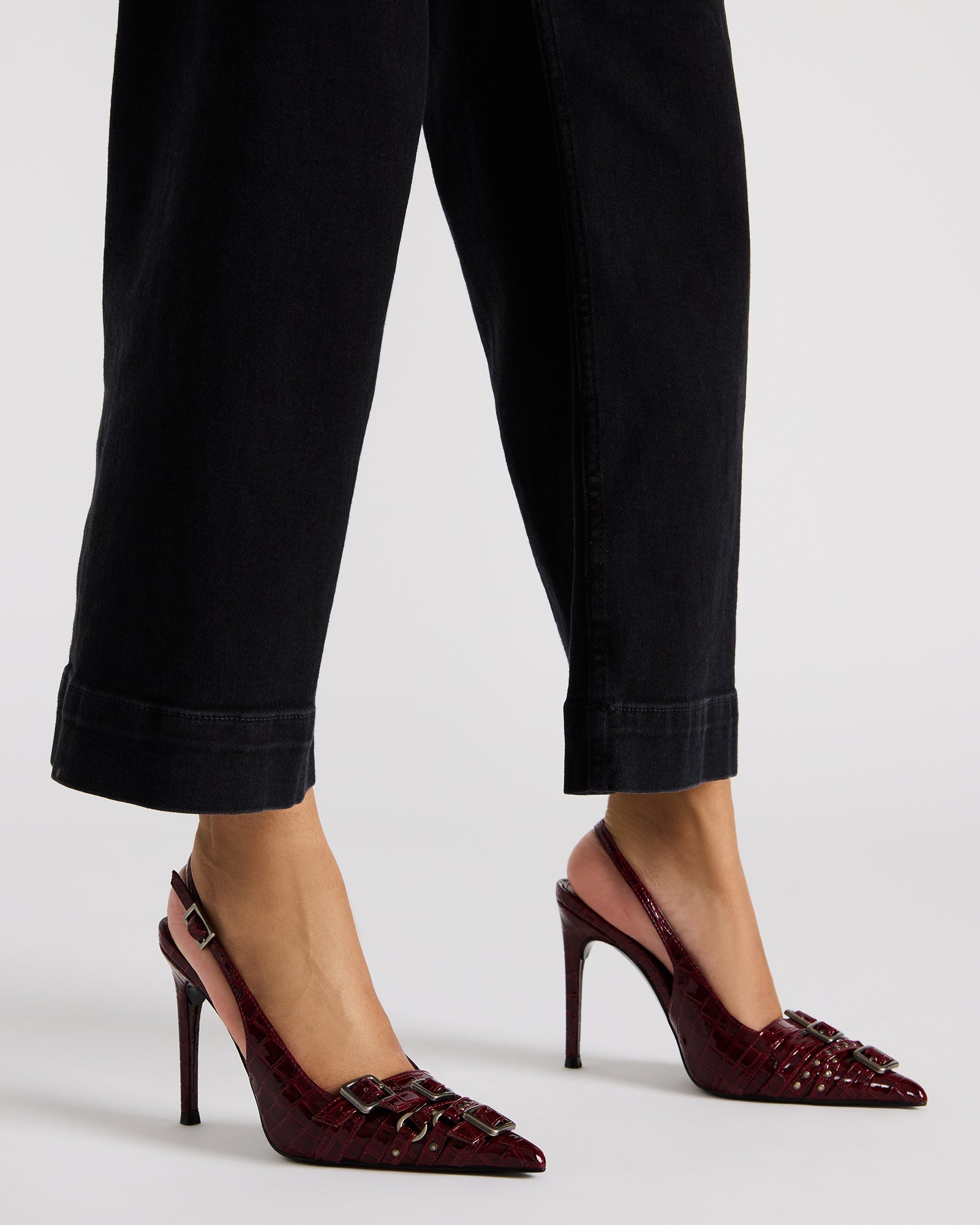 Woman walking confidently in grey high heels on city pavement