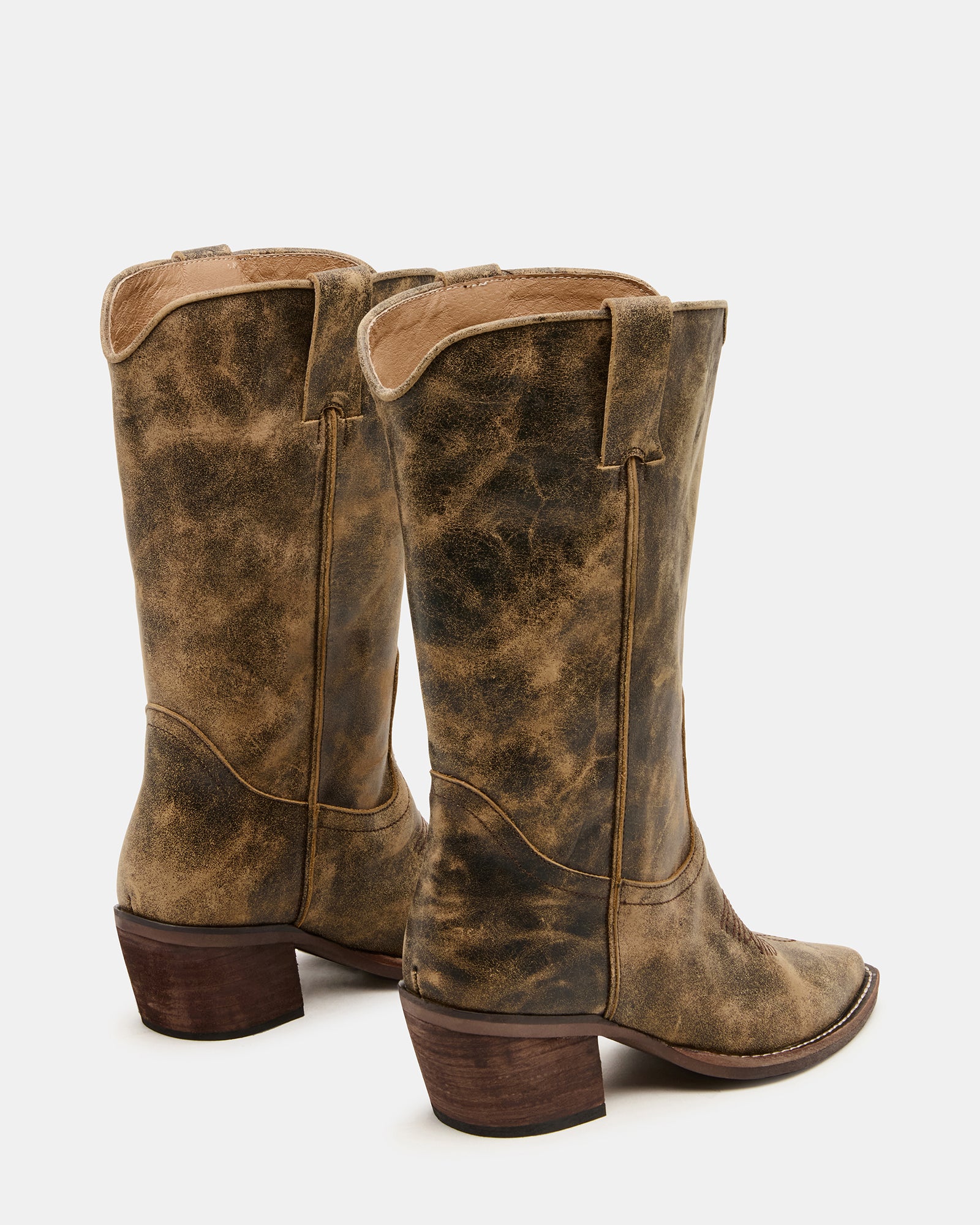 Front angle of knee-high boots with pointed toe and Western stitching.