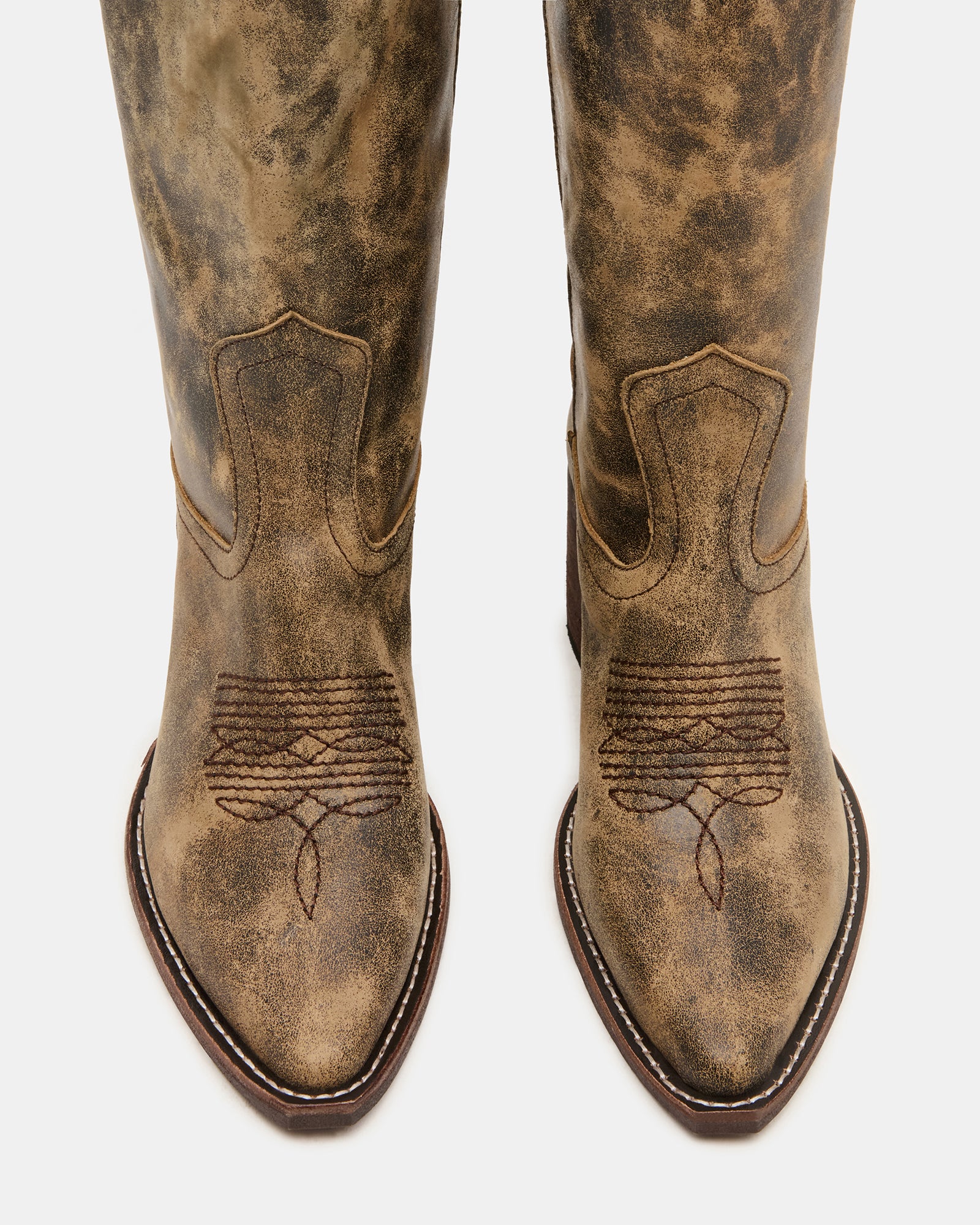 Side view of wide calf cowgirl boots showcasing distressed leather texture.