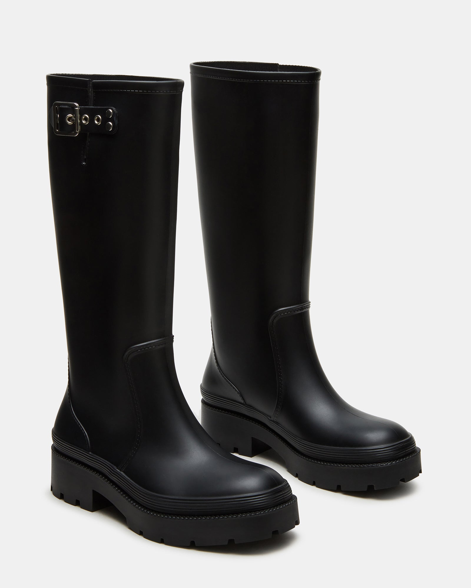 Woman wearing waterproof rain boots while walking in the rain