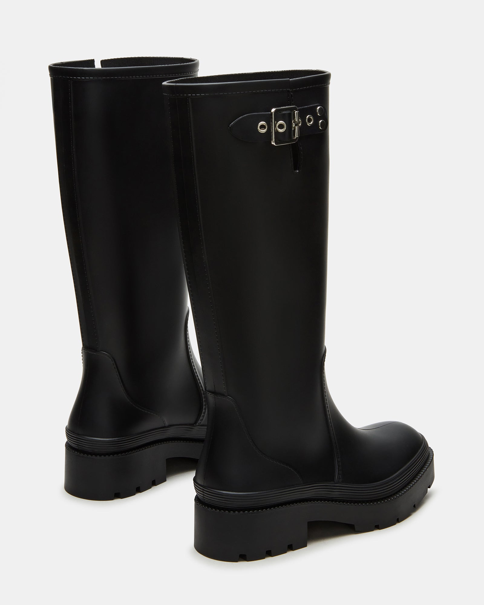 Woman wearing waterproof rain boots while walking in the rain