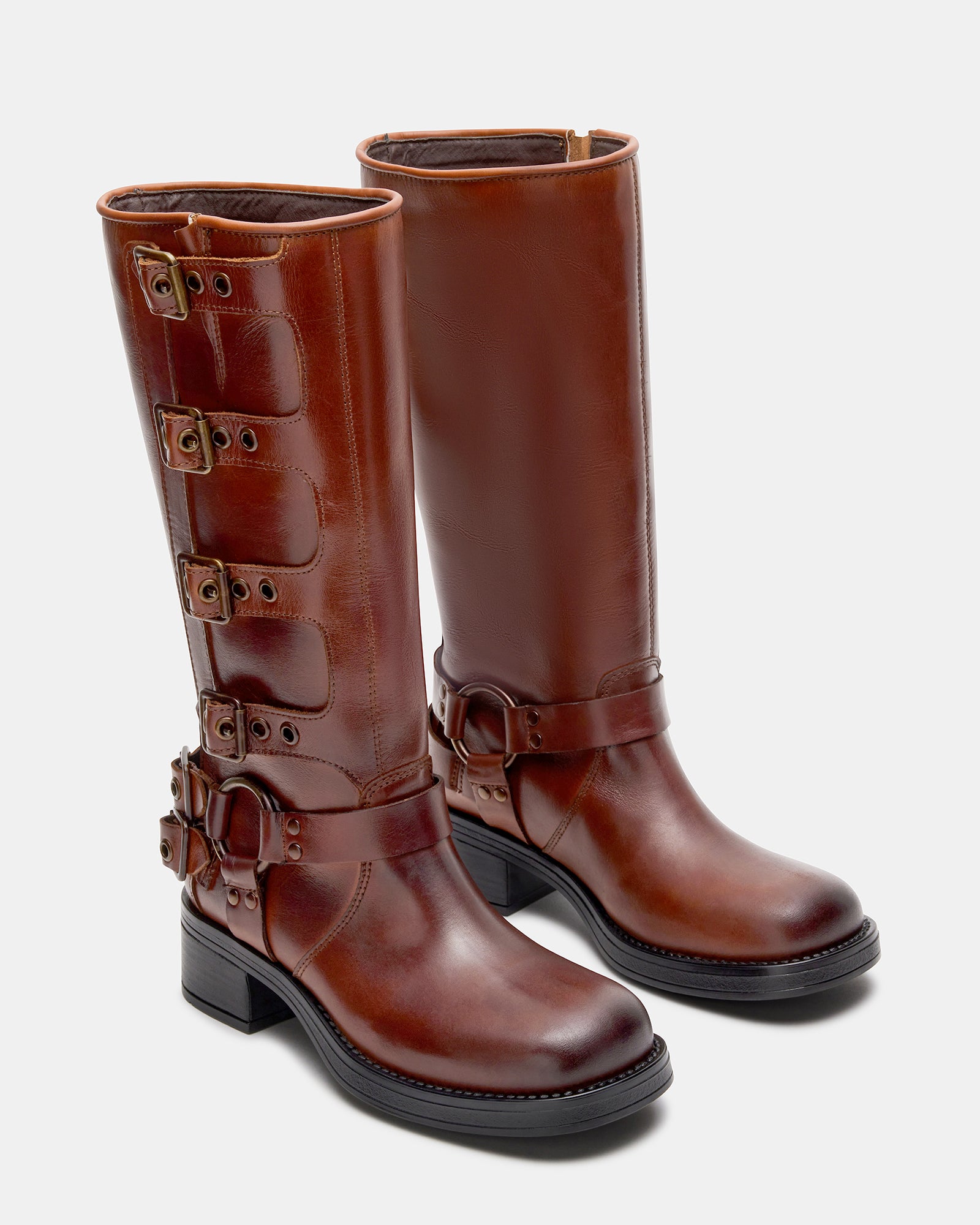 Woman wearing brown leather knee high boots, perfect for urban adventures.