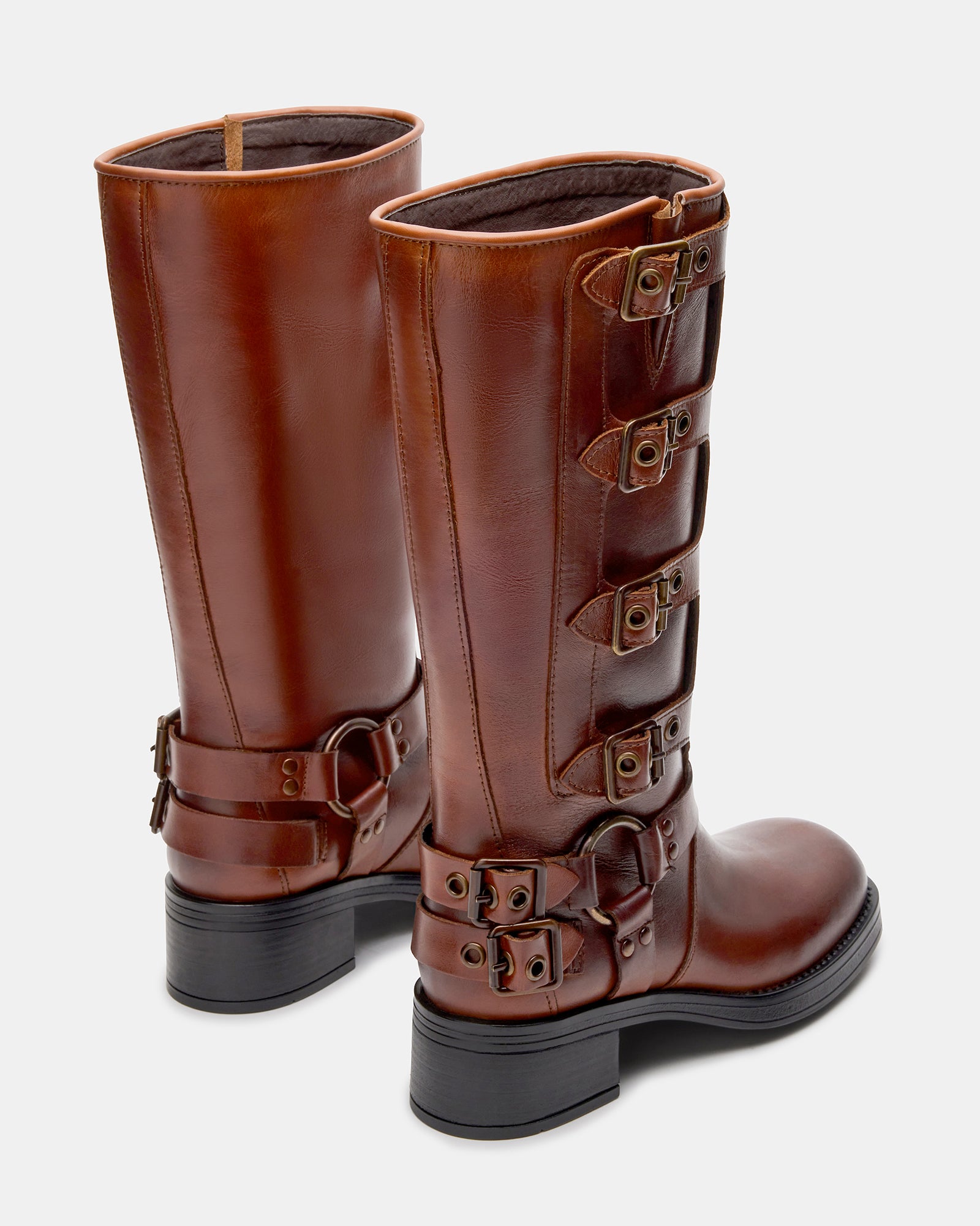 Woman wearing brown leather knee high boots, perfect for urban adventures.