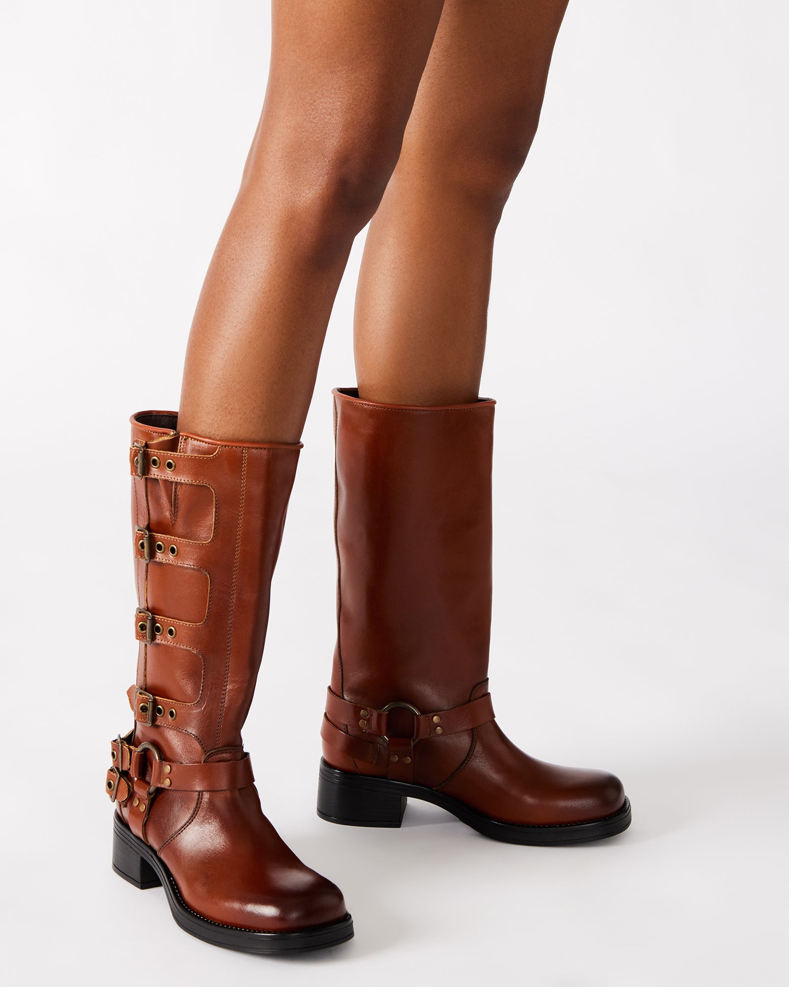 Close-up of the adjustable buckle straps on womens leather knee high boots.