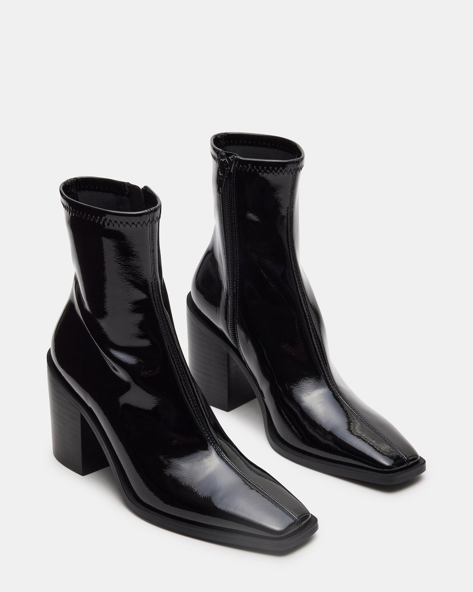 Woman wearing black ankle boots with synthetic sock detail