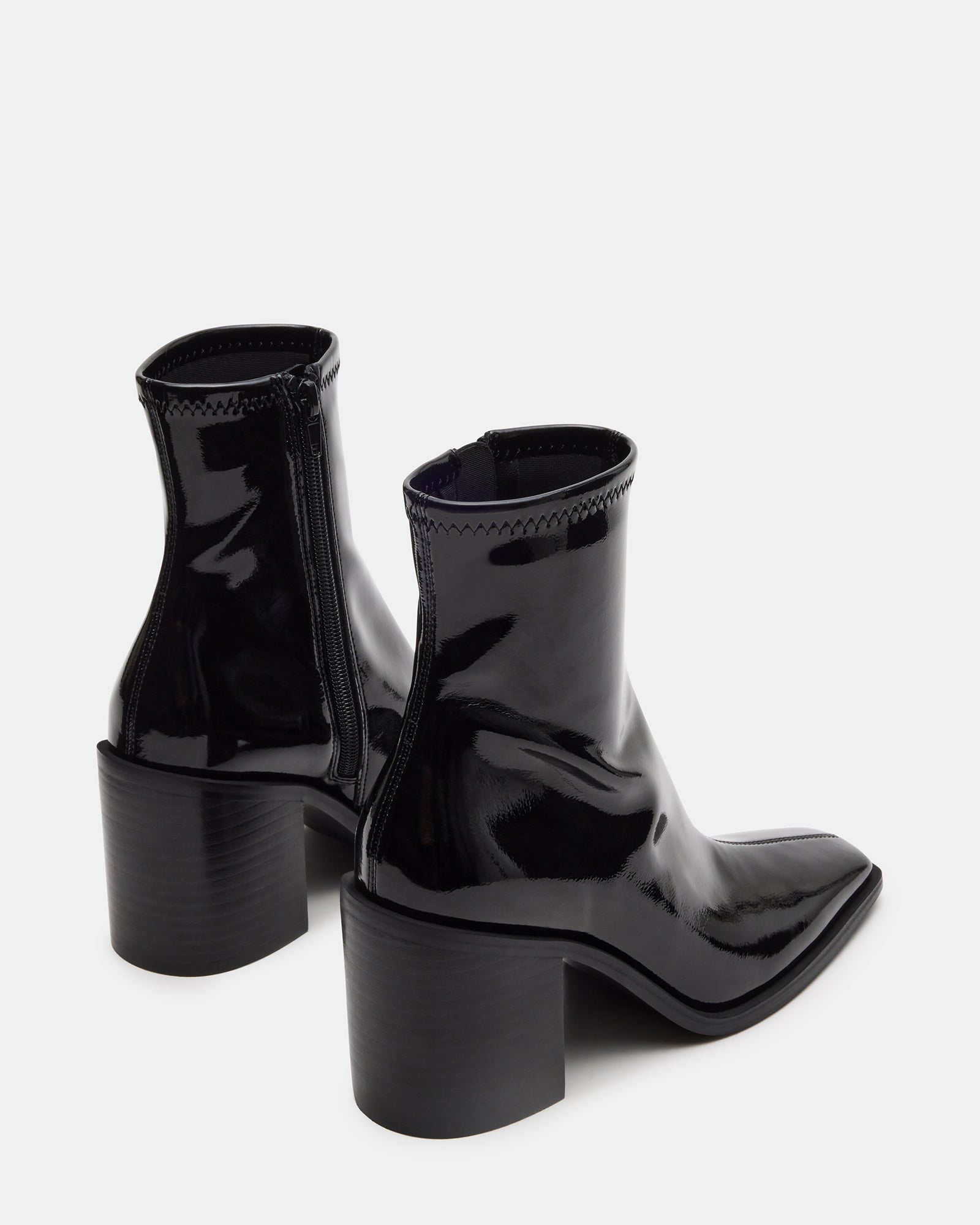 Woman wearing black ankle boots with synthetic sock detail