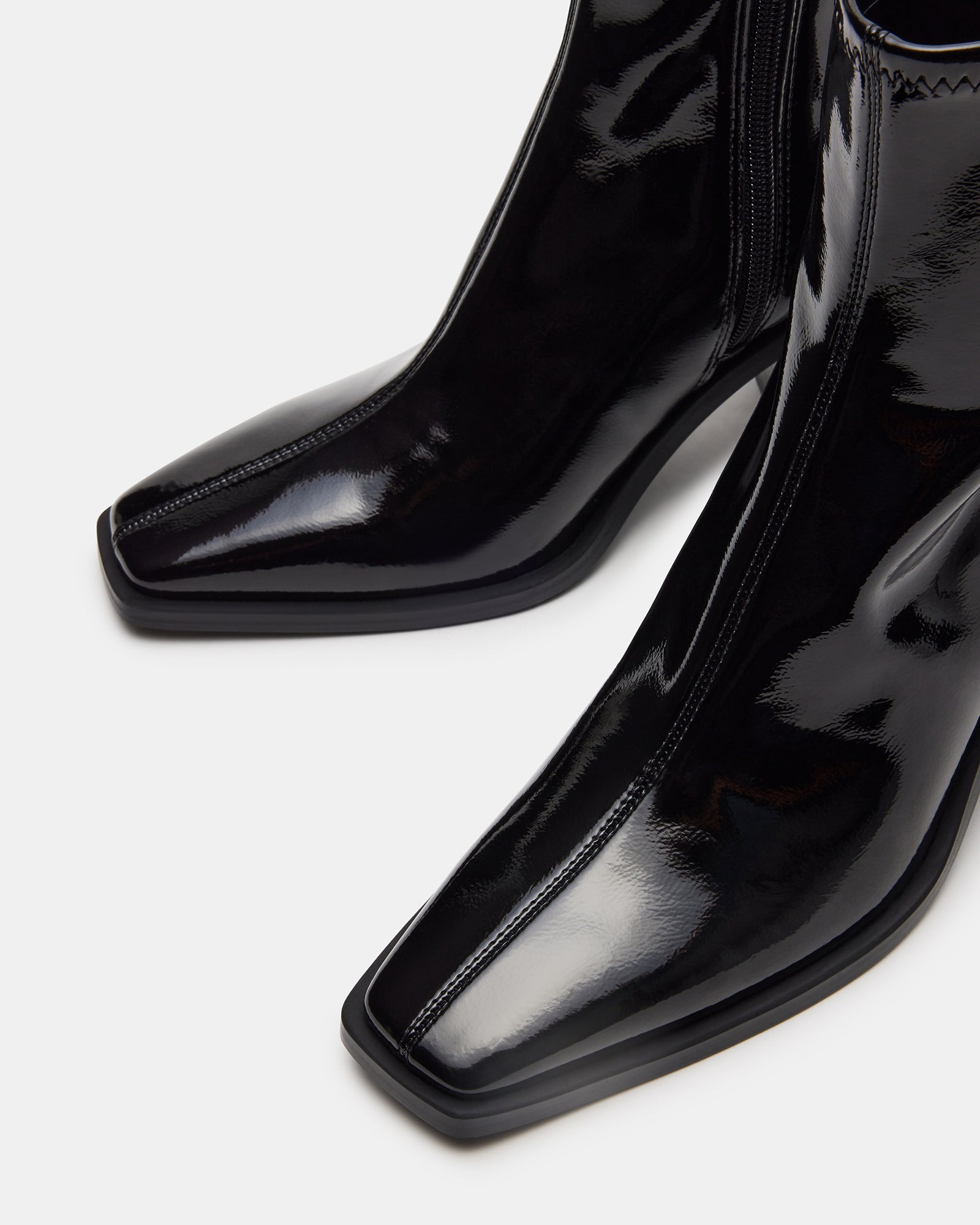 Close-up of the textured synthetic sole and heel of womens ankle boots