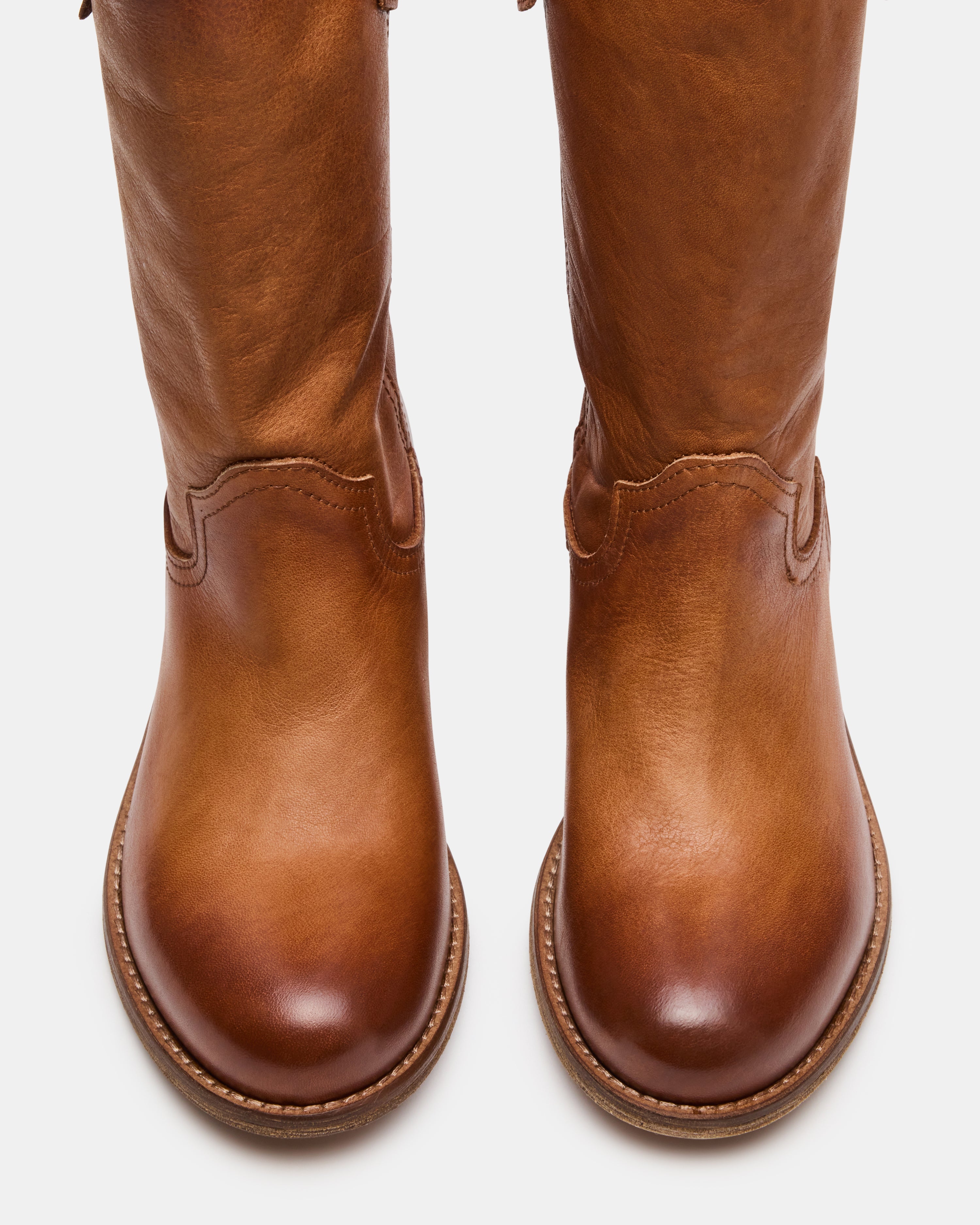 Side view of Ruben Cognac Leather Dress Boots, highlighting their sleek design.