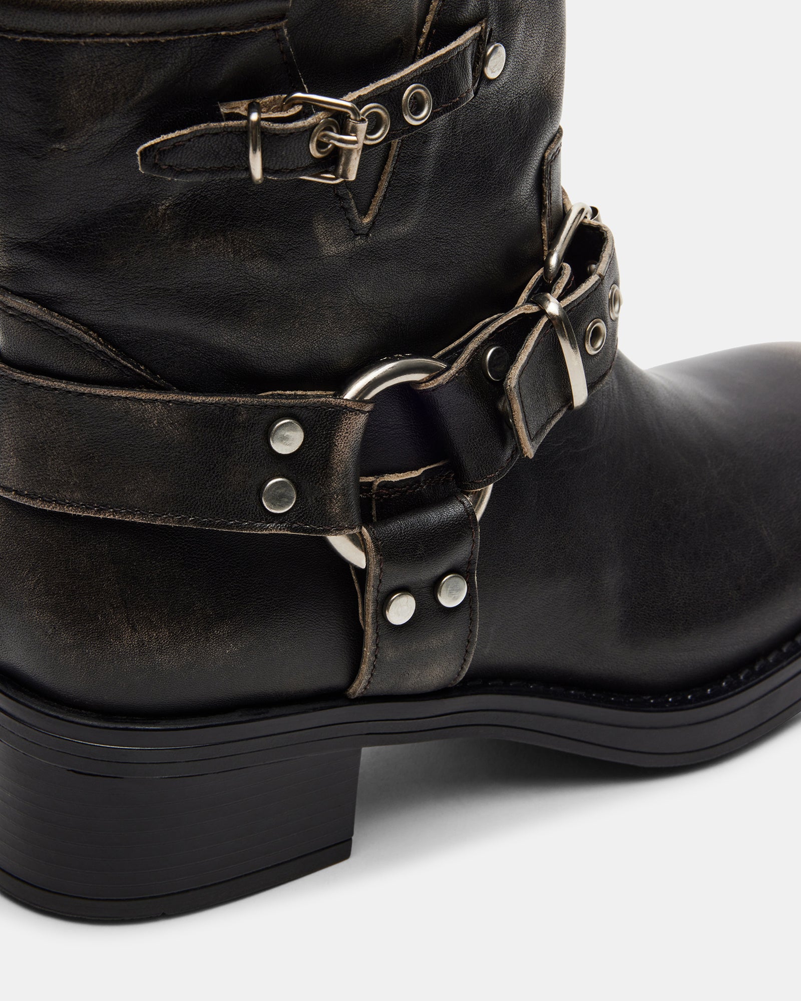 Outfit pairing: moto boots with dark jeans and a blazer.