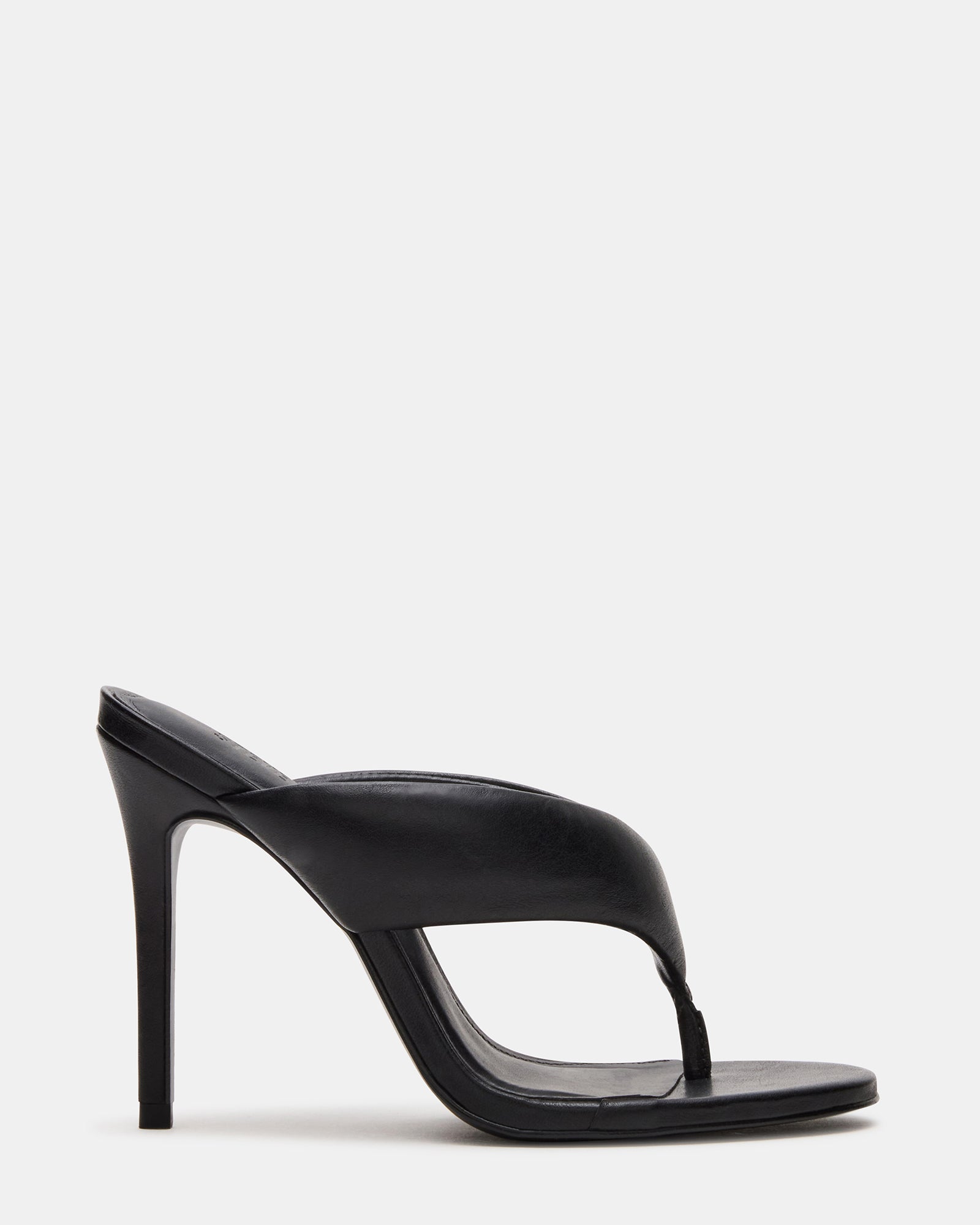 Side view of elegant black high heel mules on a model.