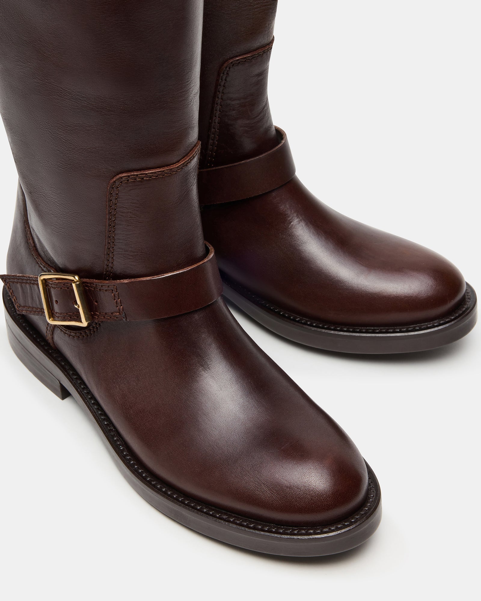 Model wearing stylish brown boots leather womens paired with a casual outfit.